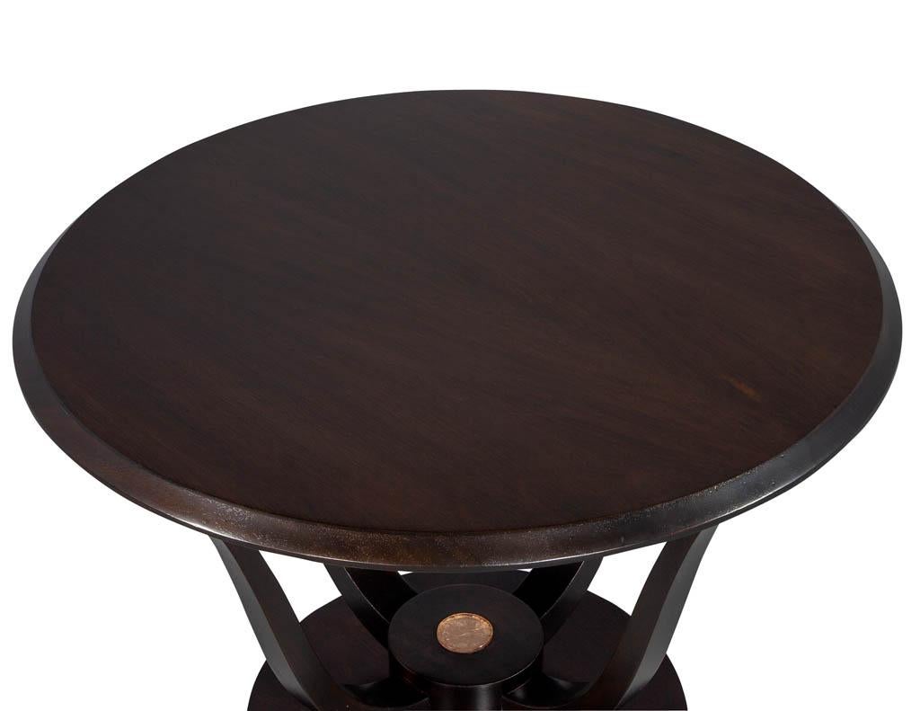 French Art Deco round occasional table. Round bevelled top with a four legged pedestal accented by an inset Lucite centre-piece. Newly restored in an espresso satin finish.