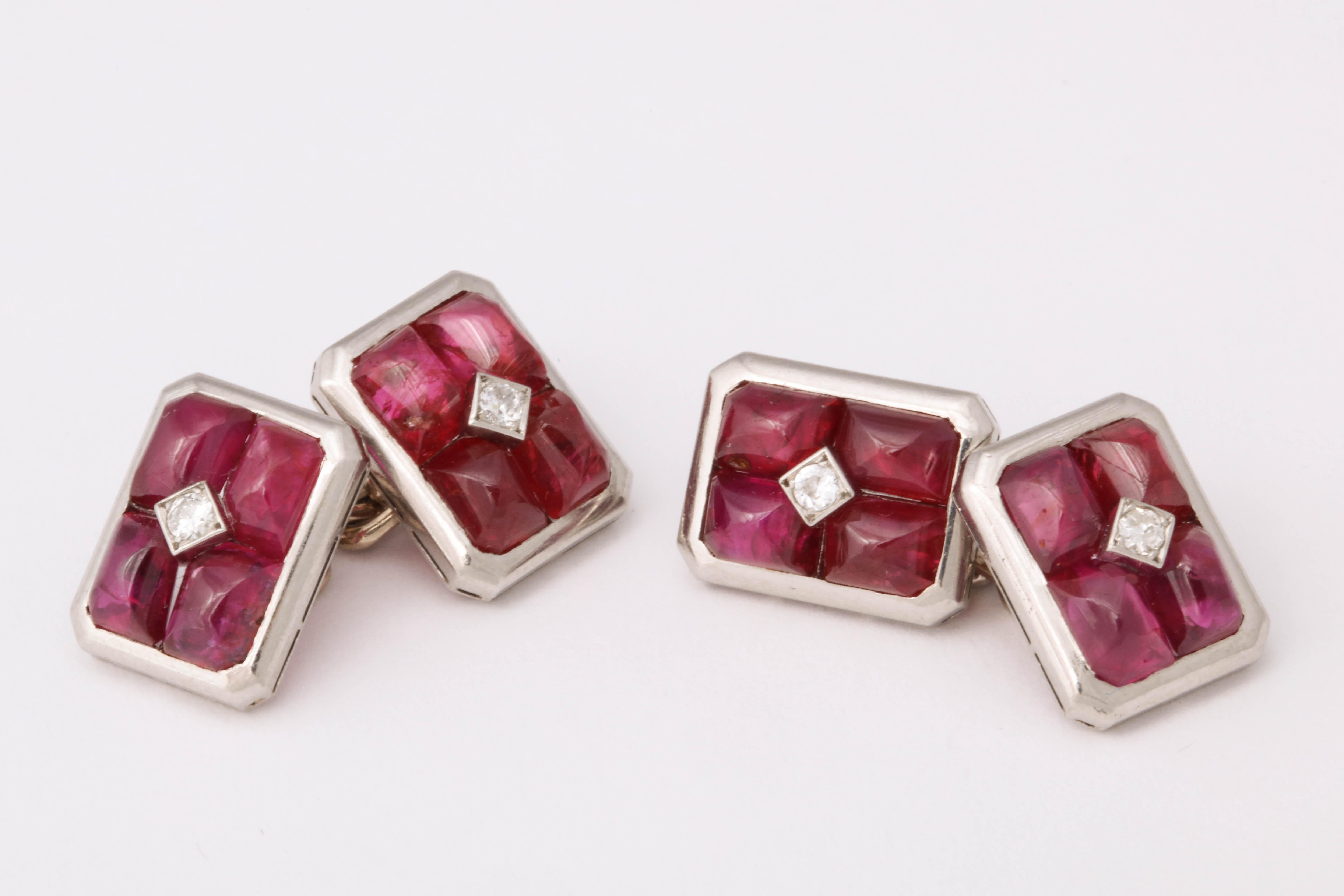 Four cabochon rubies surround a central diamond. Set in platinum. Made in France c. 1935. 