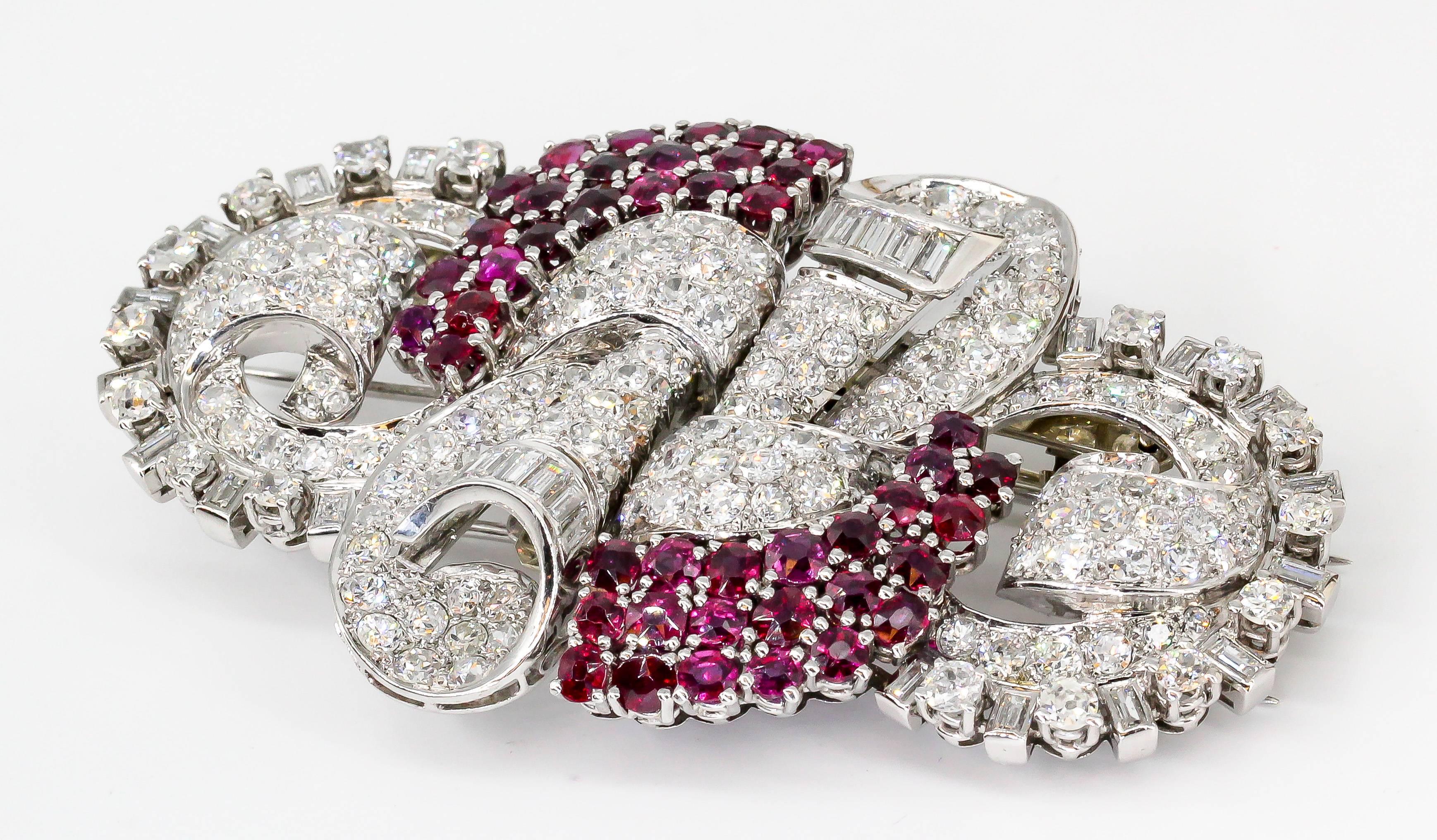 Impressive ruby, diamond, platinum and 18K gold double-clip brooch of French origin, circa Art Deco period (1920s-1930s). It features high grade round and baguette cut diamonds throughout, along with rich red rubies over a platinum setting and 18K