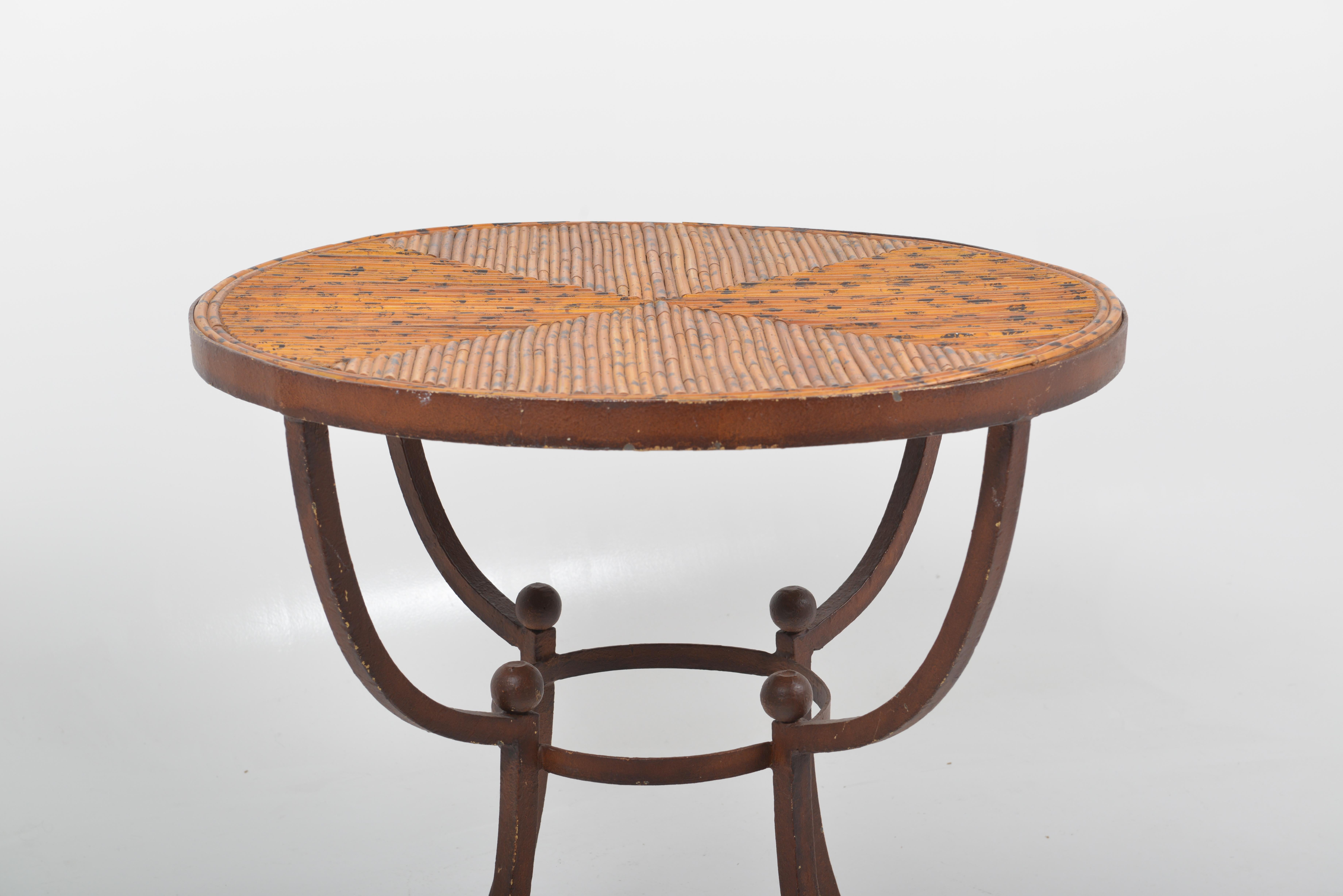 A bamboo and cast iron side table, France, 1920.

Unusual rustic or country house style art deco side table, made for a garden room or orangerie. The base is in a brownish patinated cast iron. The top is a parquetry of split bamboo painted with