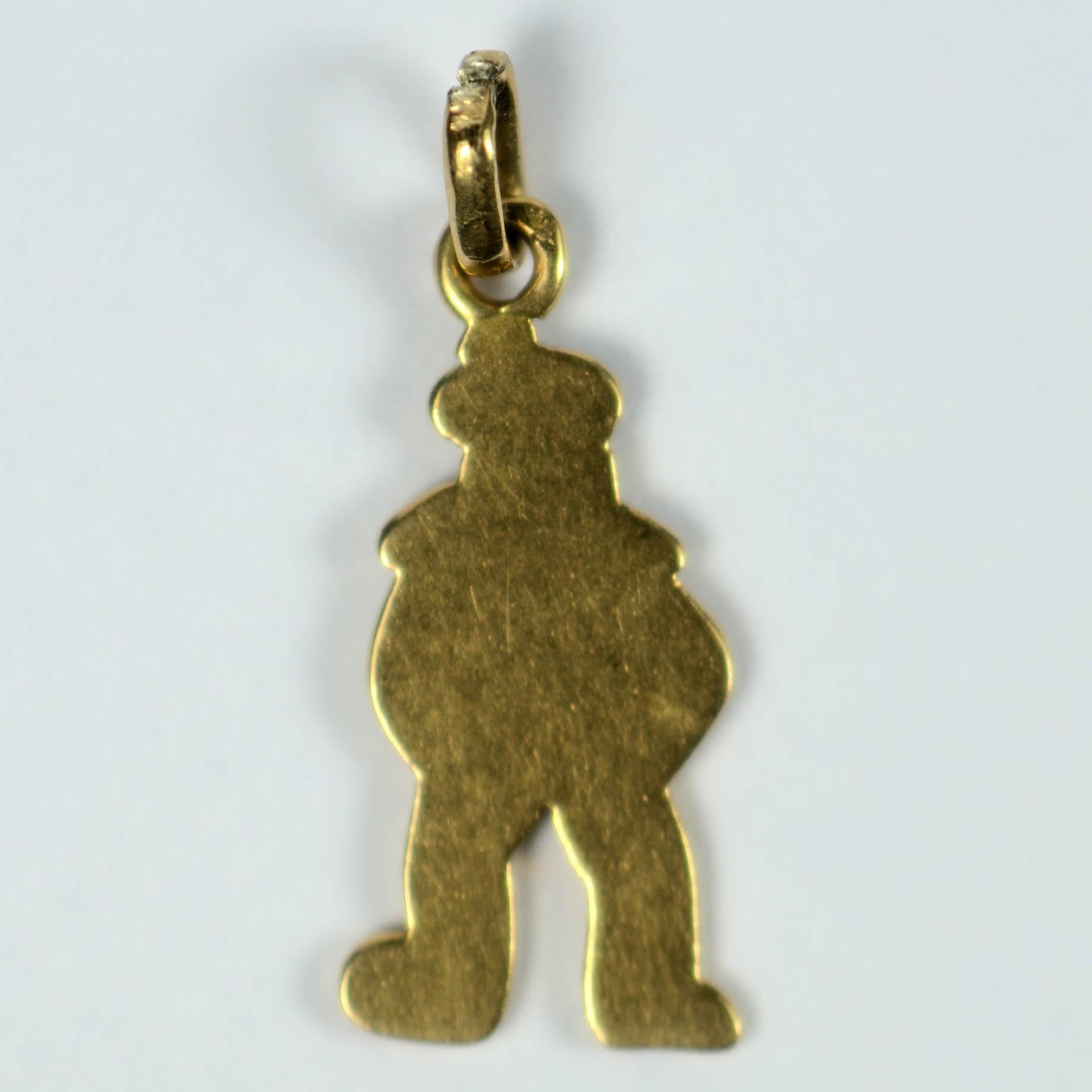 A French Art Deco charm designed as a sailor in enamel on 18 karat gold. Stamped with the eagle's head for Parisian manufacture. 3/4