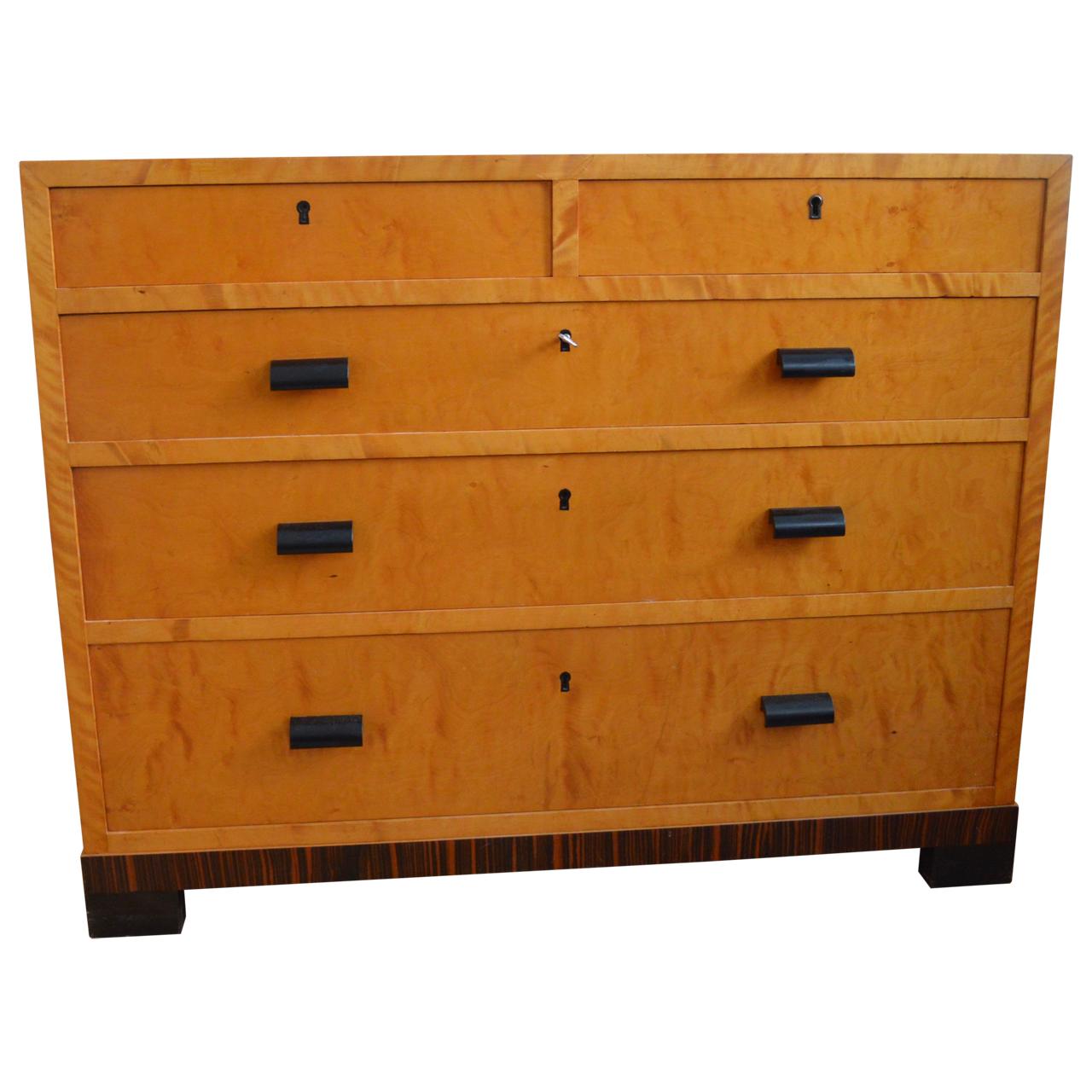 Beautiful rectangular satinwood dresser with clean lines and bird’s-eye maple and zebra wood veneer.
The dressers has three large drawers and two smaller drawers with locks at the top.