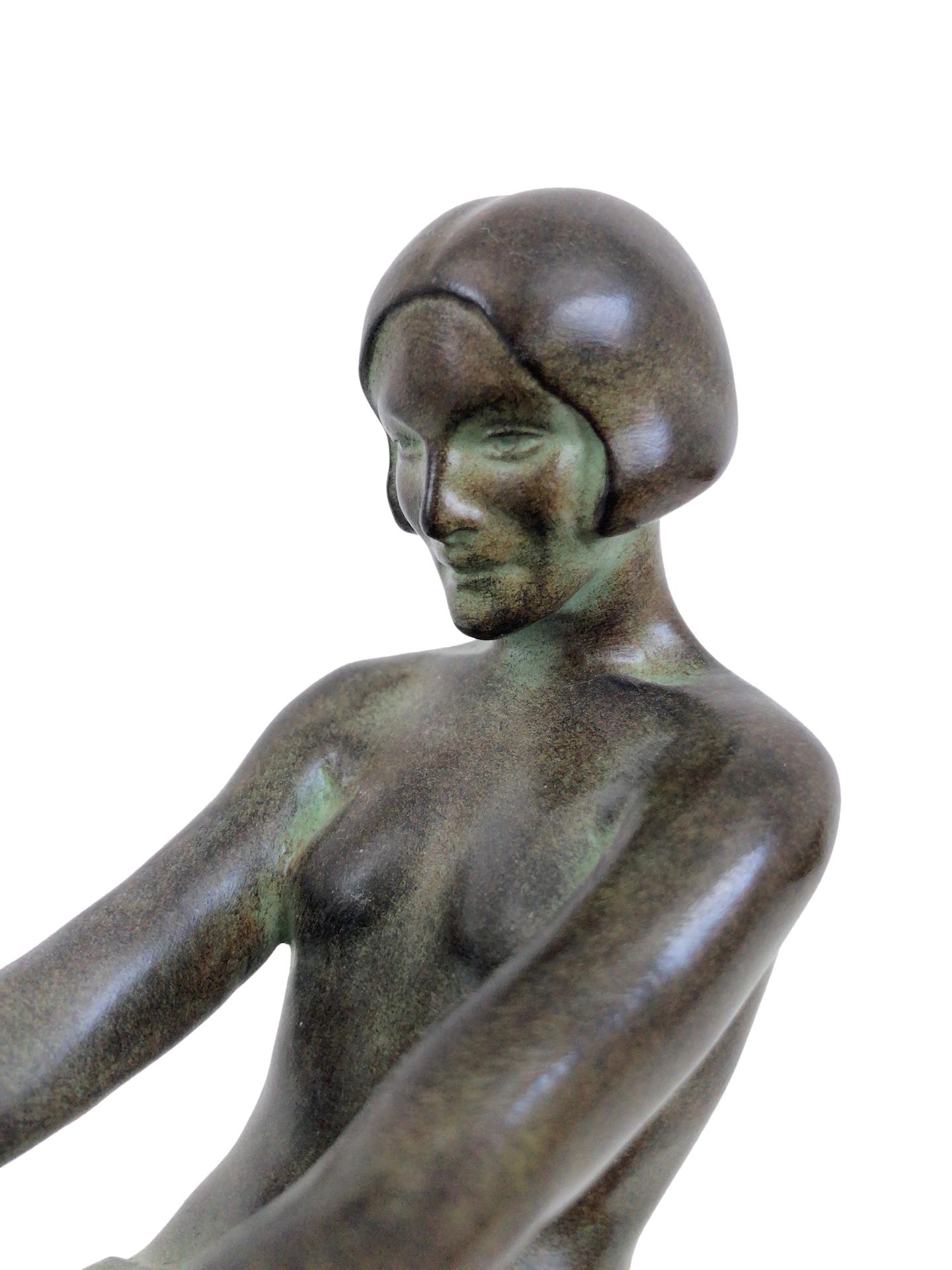 “Delassement Lumineux”
Original “Max Le Verrier”
Art Deco style, France 

Beautiful sitting lady 
Table lamp, sculpture made in “Régule” (spelter)
Socle in black marble (could have a different marbleization than the picture)
signed
Green