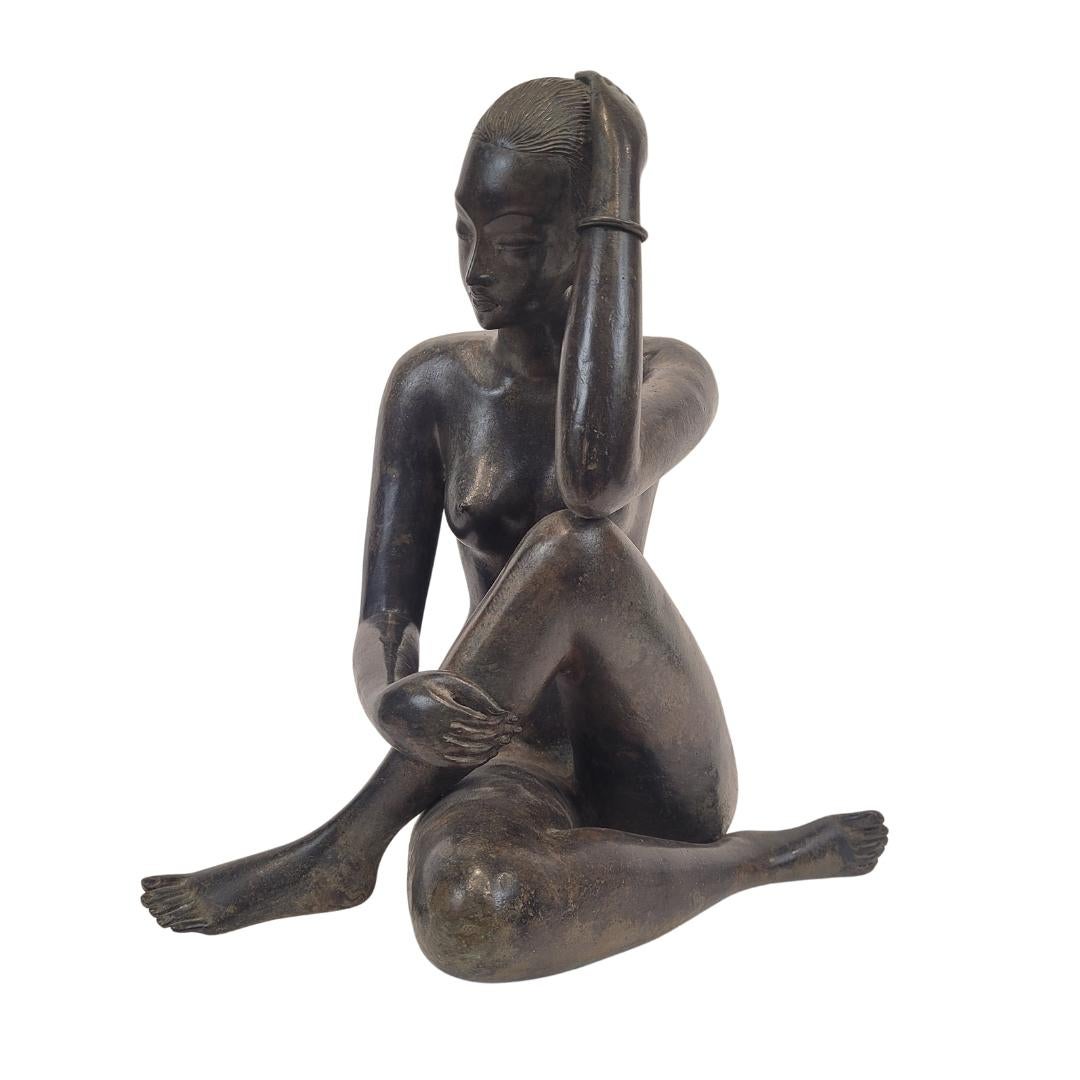 Gorgeous sculpture depicting a female nude in bronze with an ochre finish that has been achieved using a technique called “Patiné à l’acide”, which consists of applying acid to the bronze, corroding the material, giving it that ochre finish, as if