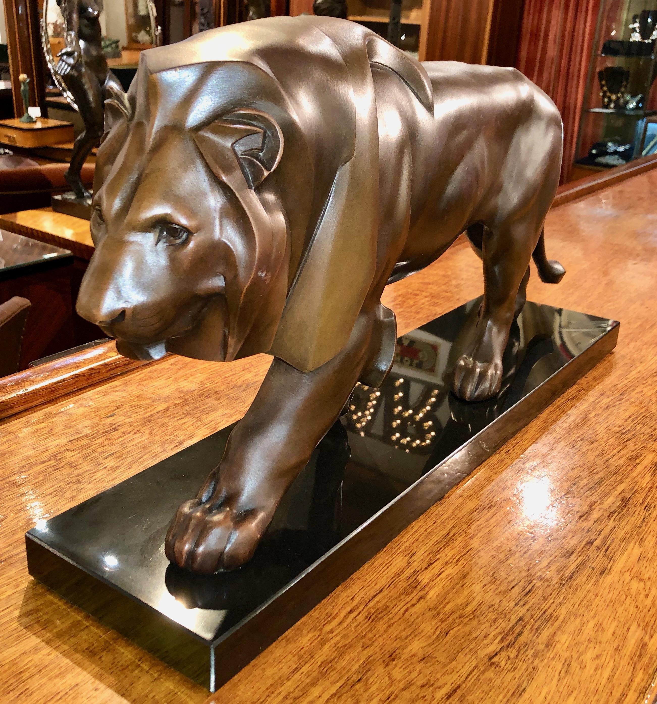 Art Deco sculpture of a walking lion by the famous French sculptor Max Le Verrier. Art metal of the highest quality with beautiful dark brown/bronze patina on a Belgian black marble base. Very impressive original statue from France circa 1920/1930.