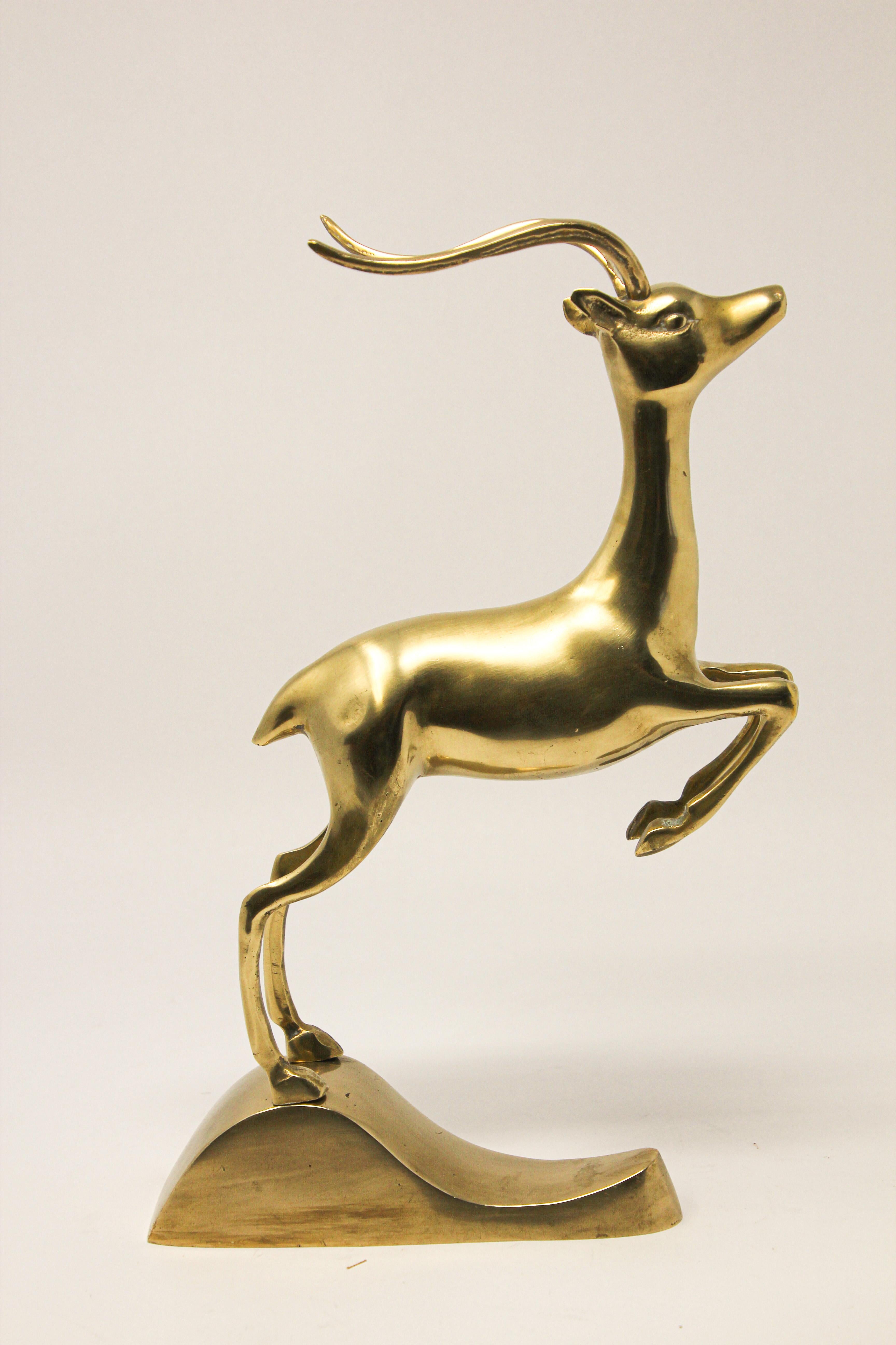 Vintage French Art Deco style brass metal animal sculpture of a leaping antelope, impala, gazelle, deer. 
Brass figurine in polished bass that serve as bookend or as individual decorative animal sculpture. 
A true Hollywood Regency sculpture Kudu,