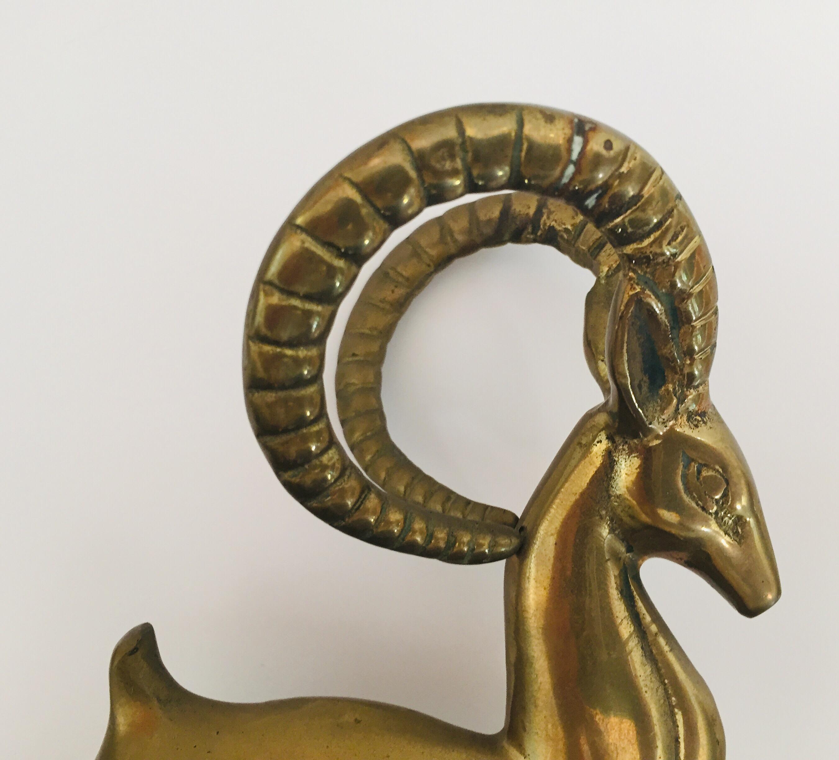 French Art Deco style brass metal animal sculpture of a gazelle, deer.
Cast brass gazelle sculpture mounted on a wooden base plate.
Great patina on brass, wood shows some wear, see pictures.