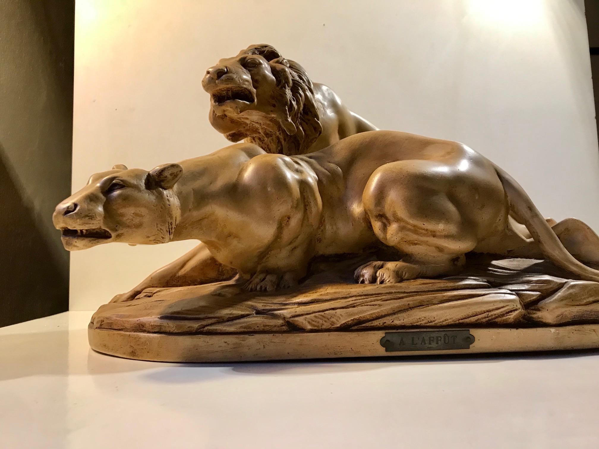 A large plaster sculpture of a Lioness and a Lion. Vivid details with a lot of 'movement' and muscularity. It is titled L' Affut (trans: lying waiting/on the look-out), signed by the artist A. Martinez and dated 1924, Paris. It is numbered 93