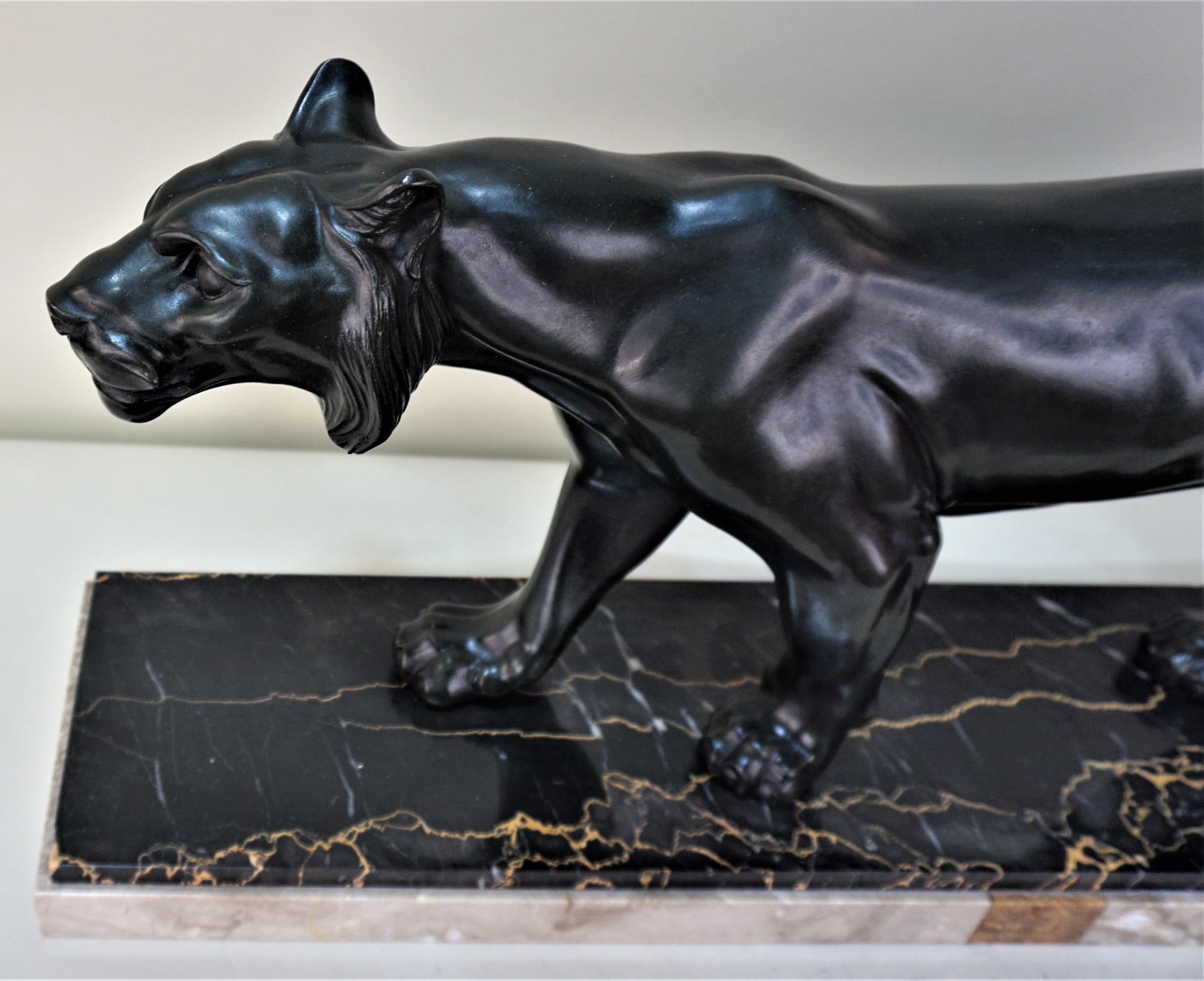 French Art Deco panther statue in dark green finish mounted on marble.
 