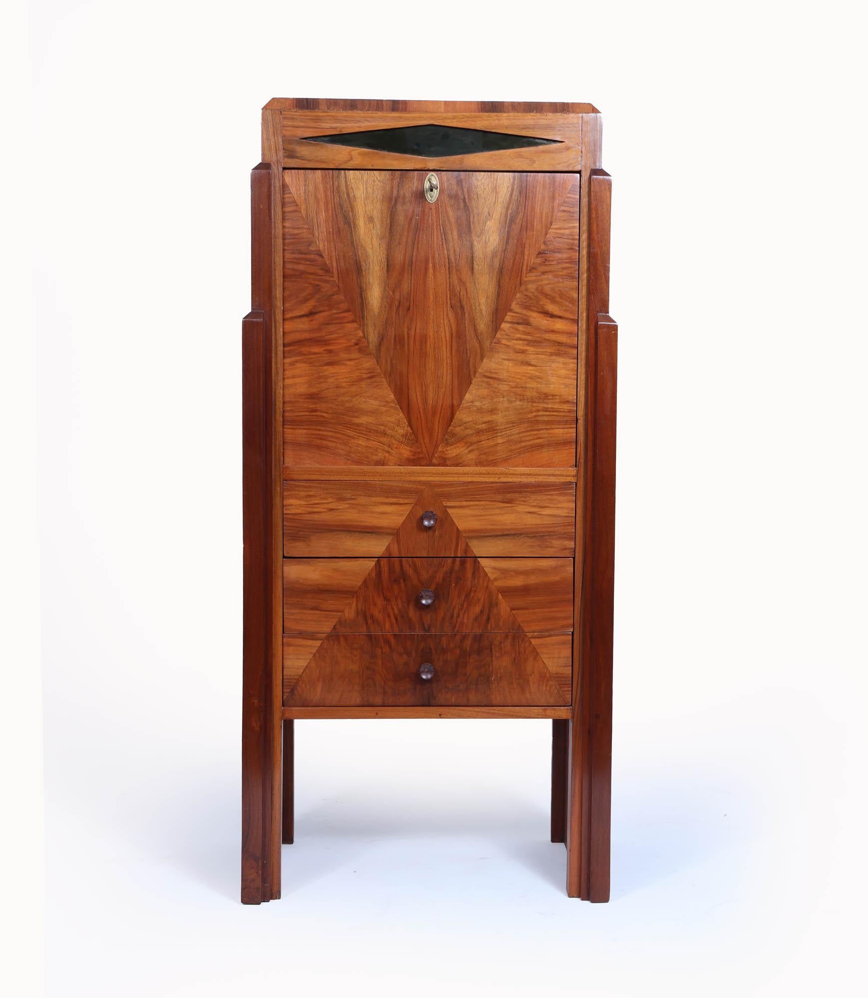 French Art Deco Secretaire Desk
A very elegant secretire with three drawers and lockable fall down front, ideal for a hallway the cabinet stands on external legs and is figured walnut with geometric design to the front of the cabinet, the top