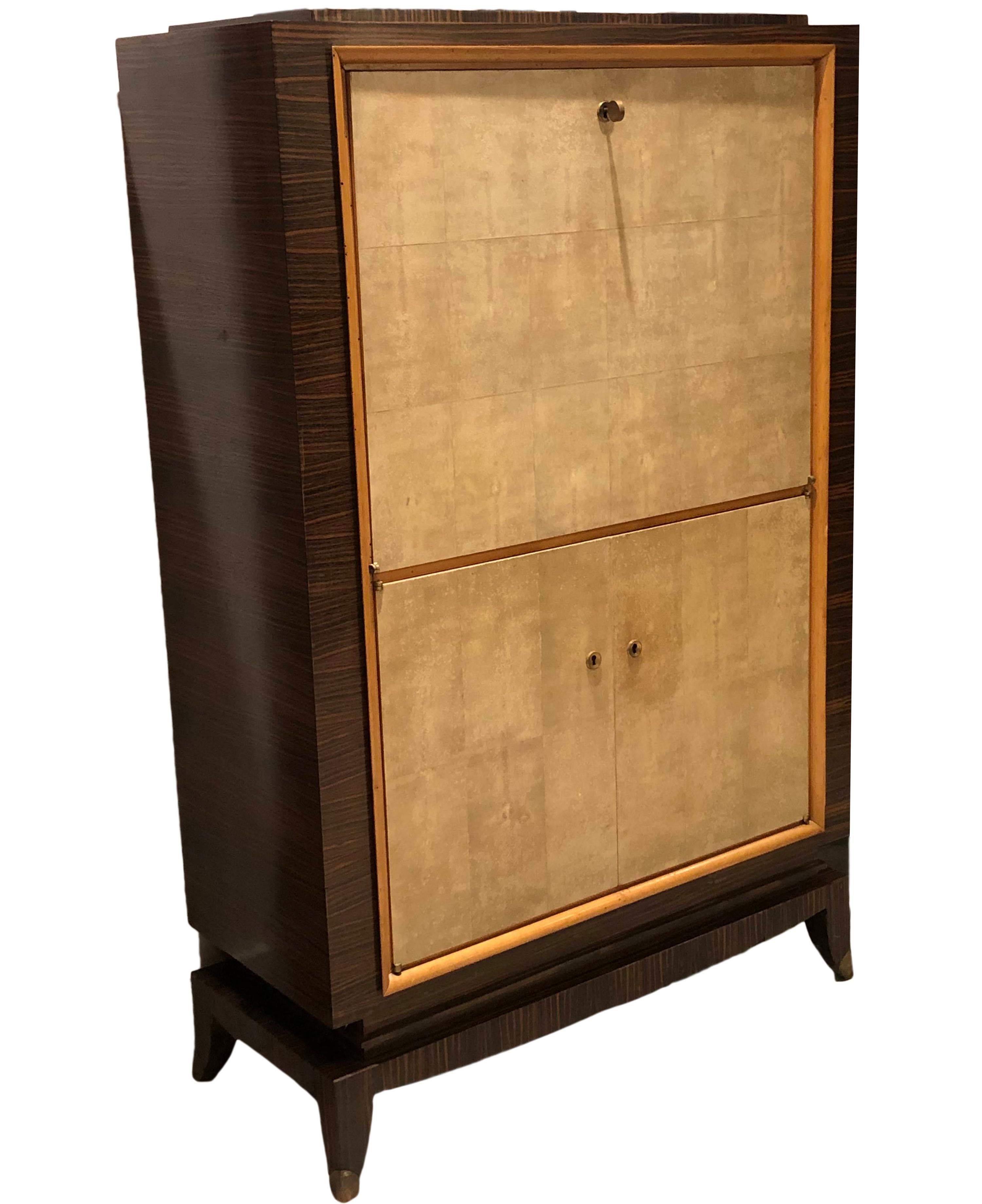 French Art Deco secretaire with rosewood and parchment exterior and sycamore interior with inside drawers and compartments.