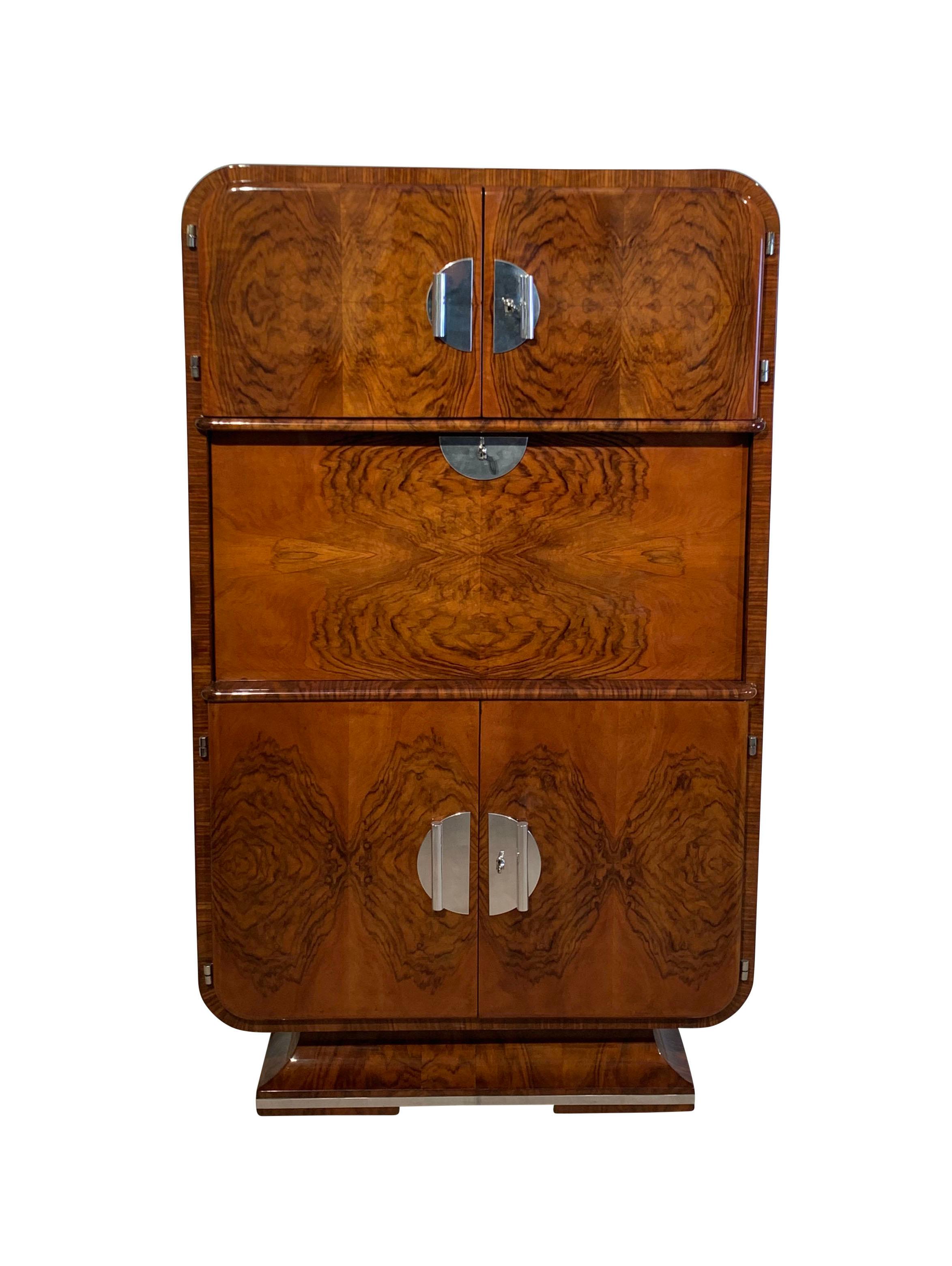 Very rare and elegant French Art Deco Secretaire / Secretary / Writing cabinet in excellently restored condition from France, circa 1930.
Wonderful design with rounded corpus and polished stainless steel trims. Amazing book-matched walnut veneer on