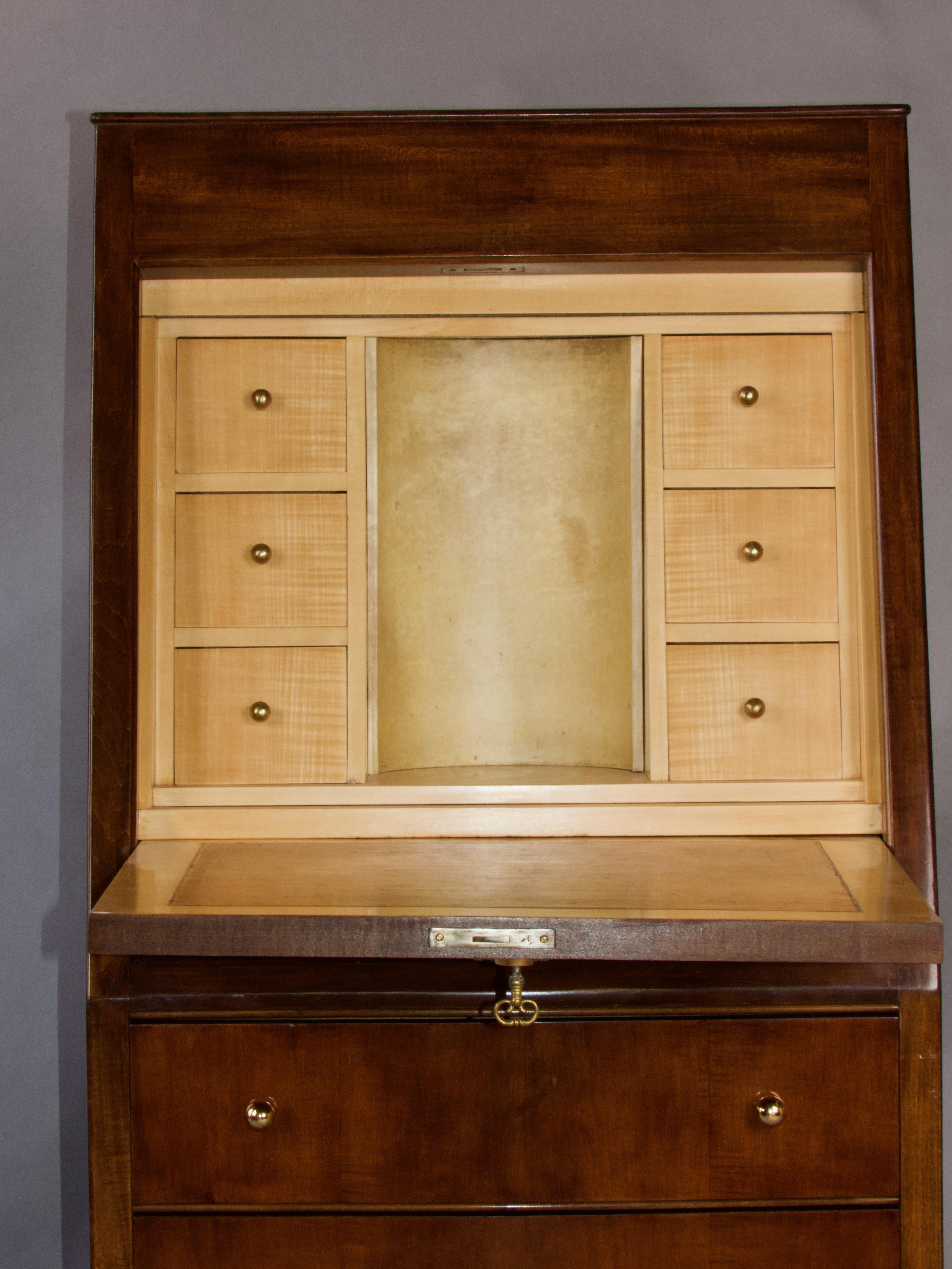 Andre Arbus Sloping mahogany secreter with two drawers and a drop-leaf door. Sycamore maple interior with six small drawers and a central niche lined with parchment; gilt bronze knobs and keyhole.
A bronze depicting a sheaf of wheat and two birds is