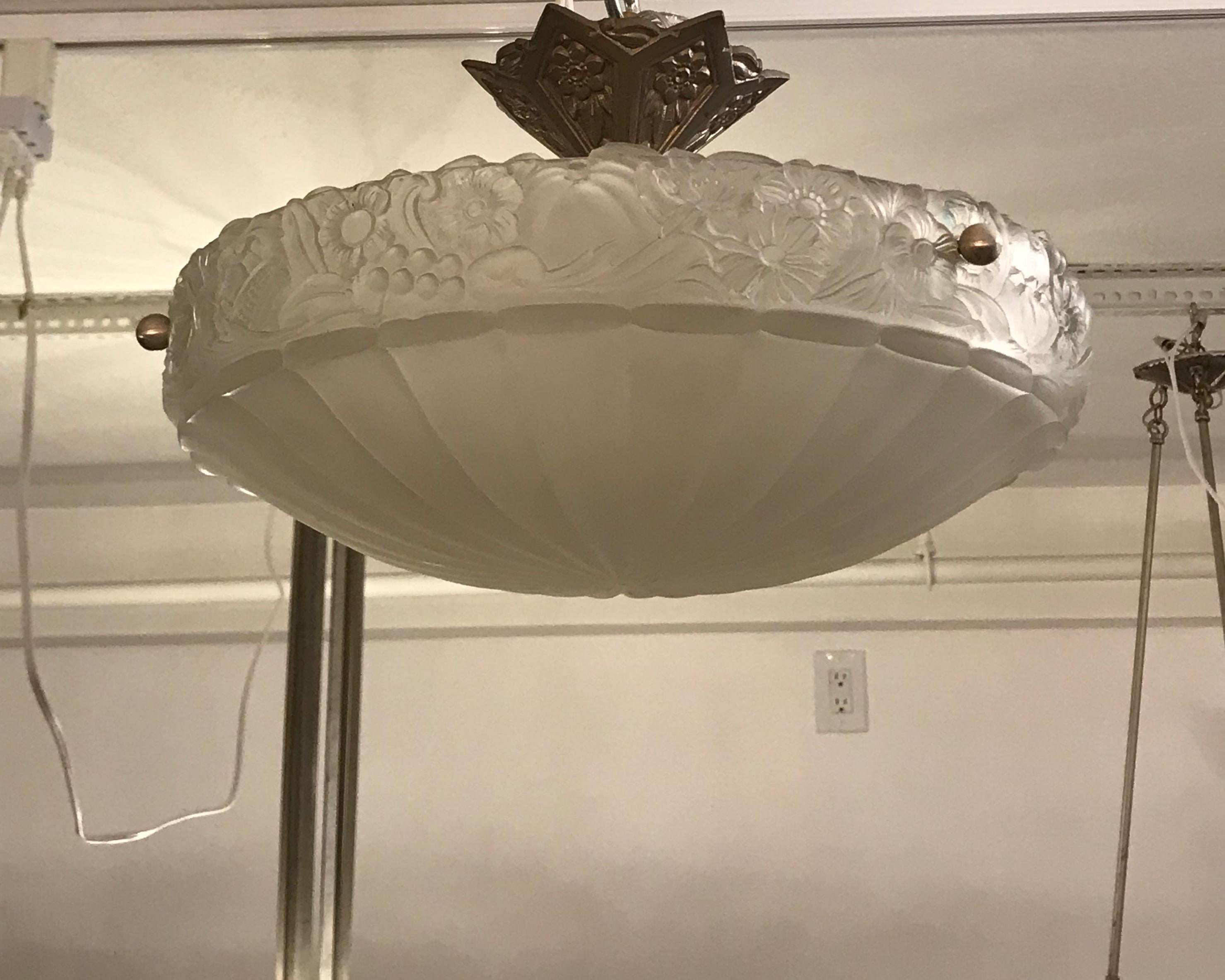 French Art Deco floral semi flush mount chandelier. Clear frosted glass with floral motif. Held by three nickel rods and matching ceiling plate. Has been rewired for American use with three candelabra sockets. Each socket has a max watt of 60 watts.