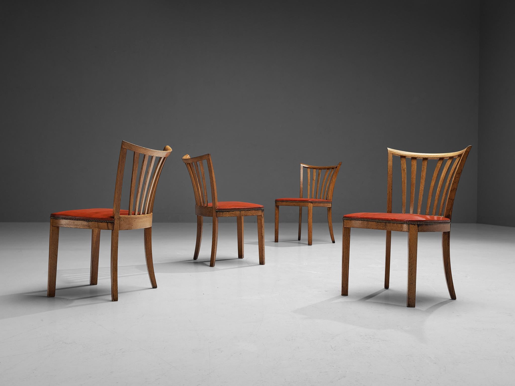Set of four dining chairs, leatherette, oak, brass, France, 1940s 

The strong, elegant form of the geometrical backrest with spindles, all executed in the finest oak is absolutely striking. Lightness is created through the slim proportions of the