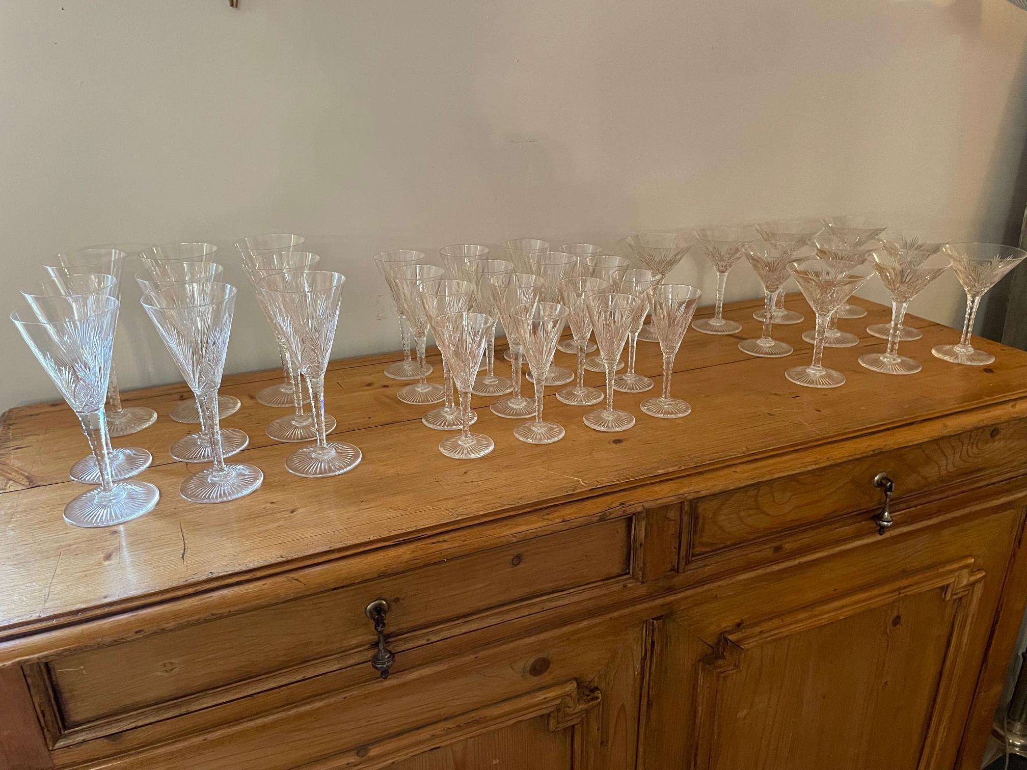 Exceptional 20th century French Art Deco set of Saint Louis Cristallerie glasses. 
- 9 red wine glasses 19X8 
- 10 champagne glasses 14X10
- 8 white wine glasses 15X6
- 8 liquor glasses 14X0
Very beautiful model of conical shape decorated with
