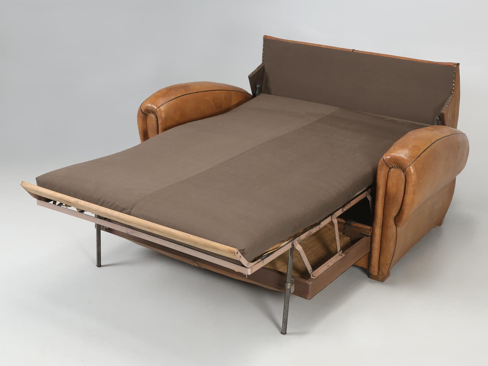 French Art Deco leather settee that also opens into a bed. Over the past 30 years we have had a couple of the French leather settees, but never in this nice of condition. The leather is absolutely all original and we basically did not have to touch