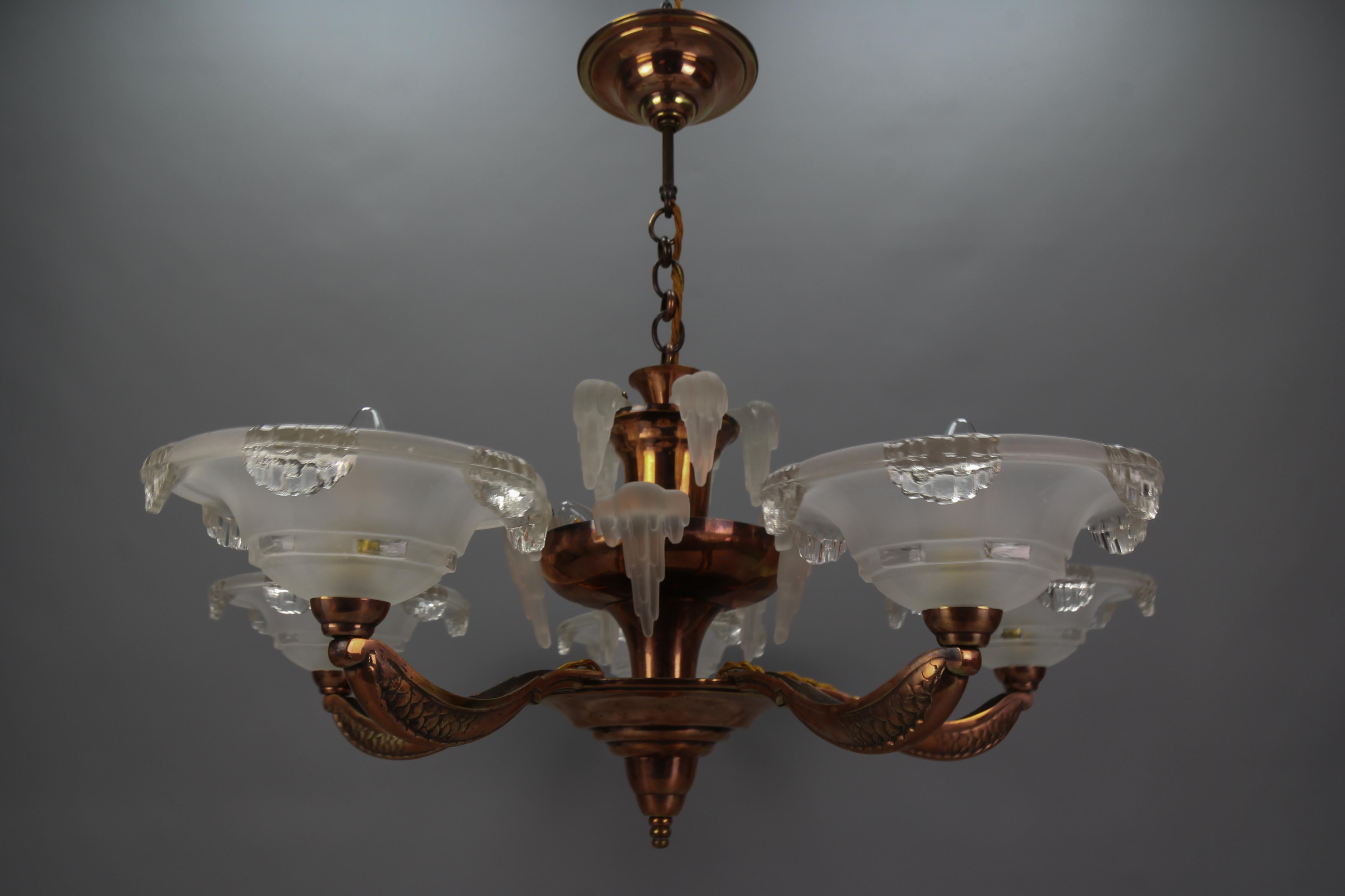 French Art Deco 7-light frosted glass, brass, and copper chandelier, circa the 1930s.
This magnificent chandelier, attributed to Ezan, typically Parisian from the 1930s, is made of copper, brass, and white frosted glass. The chandelier features a
