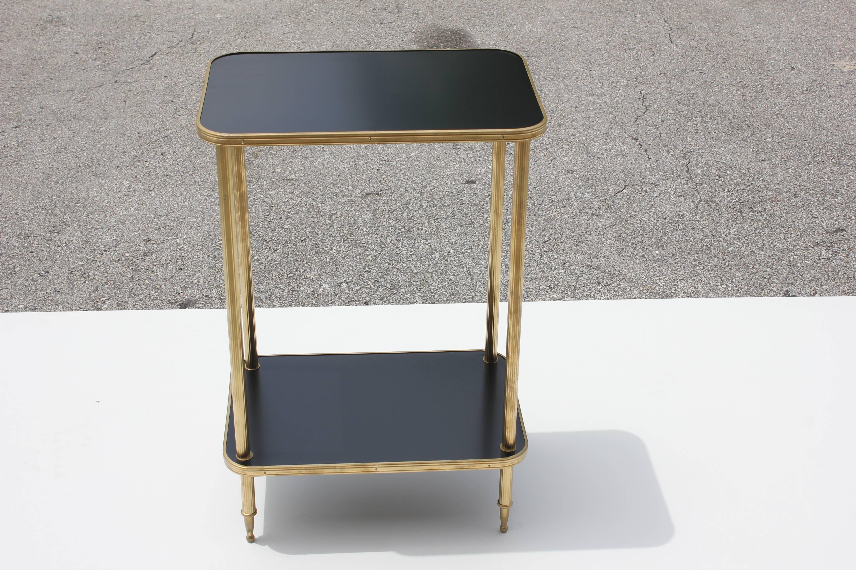 Beautiful French Art Deco side table Or end table by Maison Jansen, made of solid mahogany that have been ebonized and finished with a French polish, the table is trimmed with brass and features elegant finely brass hardware, the all frames of the