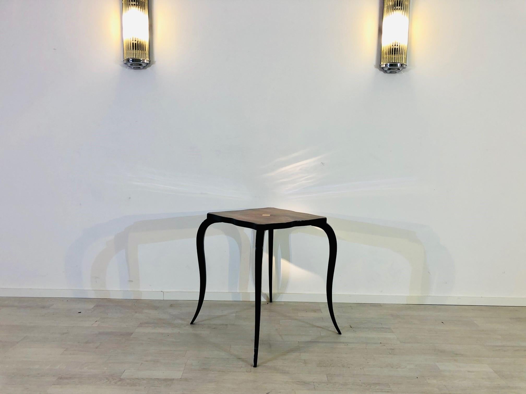 Small Art Deco side table from France. Wonderful crafted piece of furniture with a unique form and great details like a recessed check pattern in the middle of the table. The curved legs excel this single piece!

 Great contrast - black piano