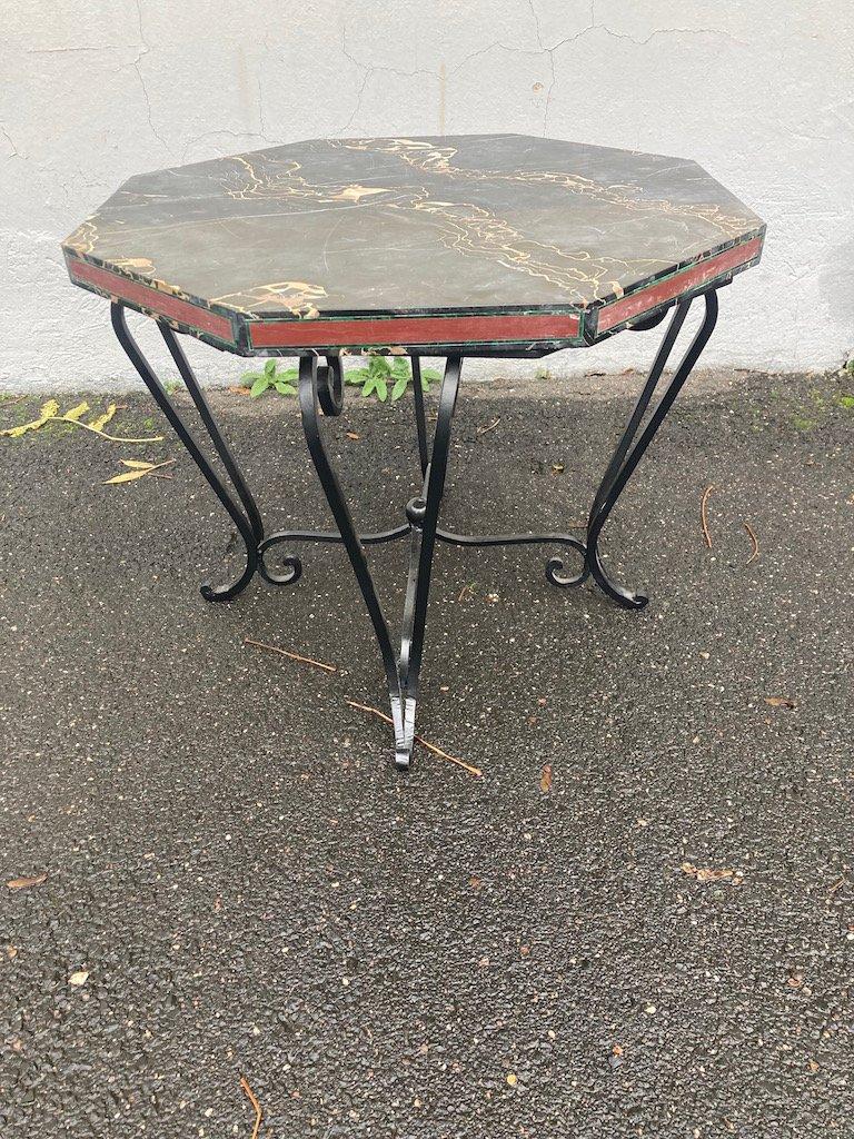 Fine low Art Déco Side Table. France 1920s.
Octagonal heavy overlaying Portoro Marble top.
The marble is of exquisite high quality, beautiful veining.
The manufacture of the frame allows the marble top to rest firmly on it.
Black lacquered iron