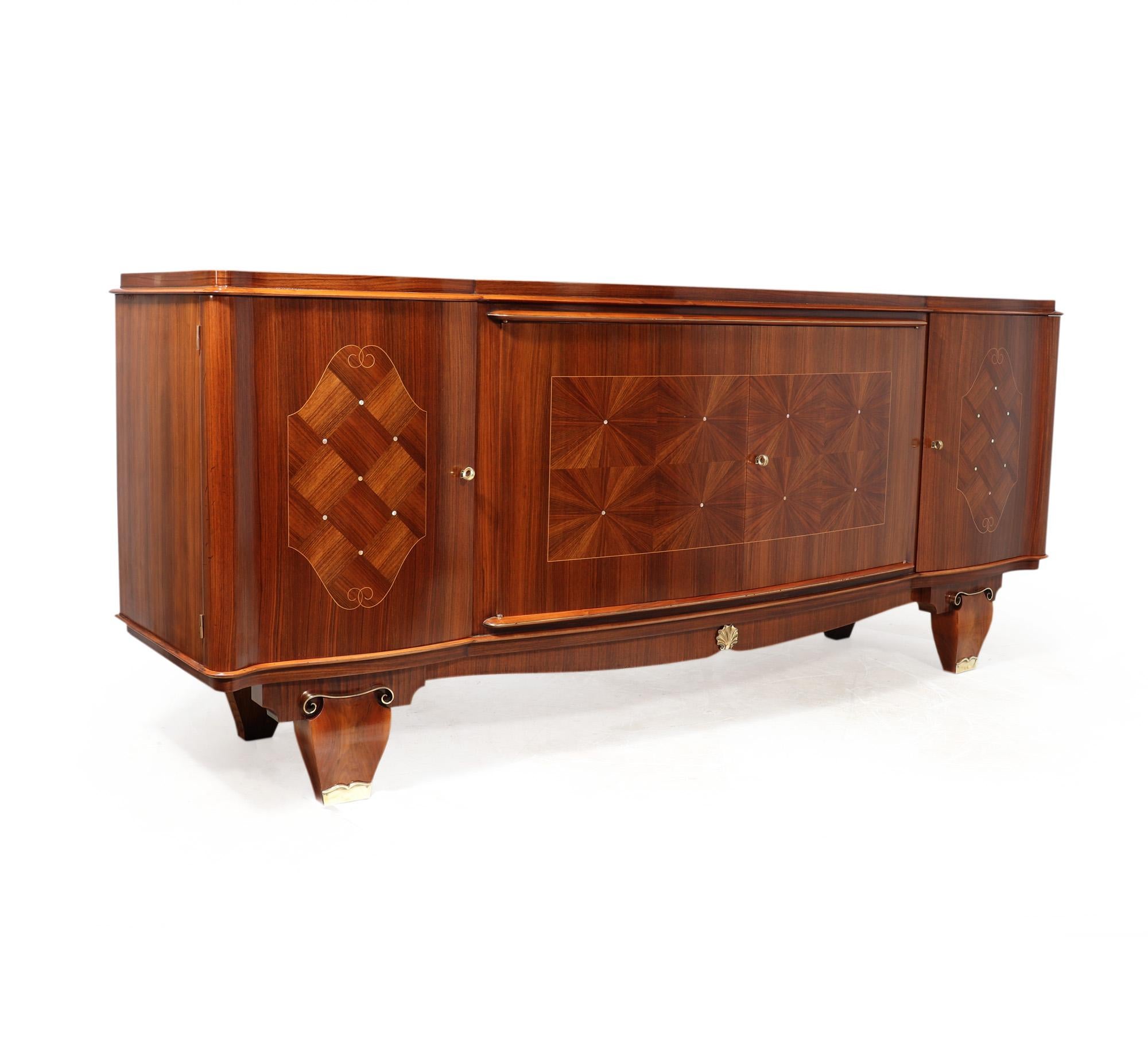 ART DECO SIDEBOARD BY JULES LELEU
A French Art Deco sideboard produced by Jules Leleu around the 1940 in straight grain walnut with parquetry and segmented inlay highlighted with mother of pearl and blonde wood stringing, the sideboard is lined with