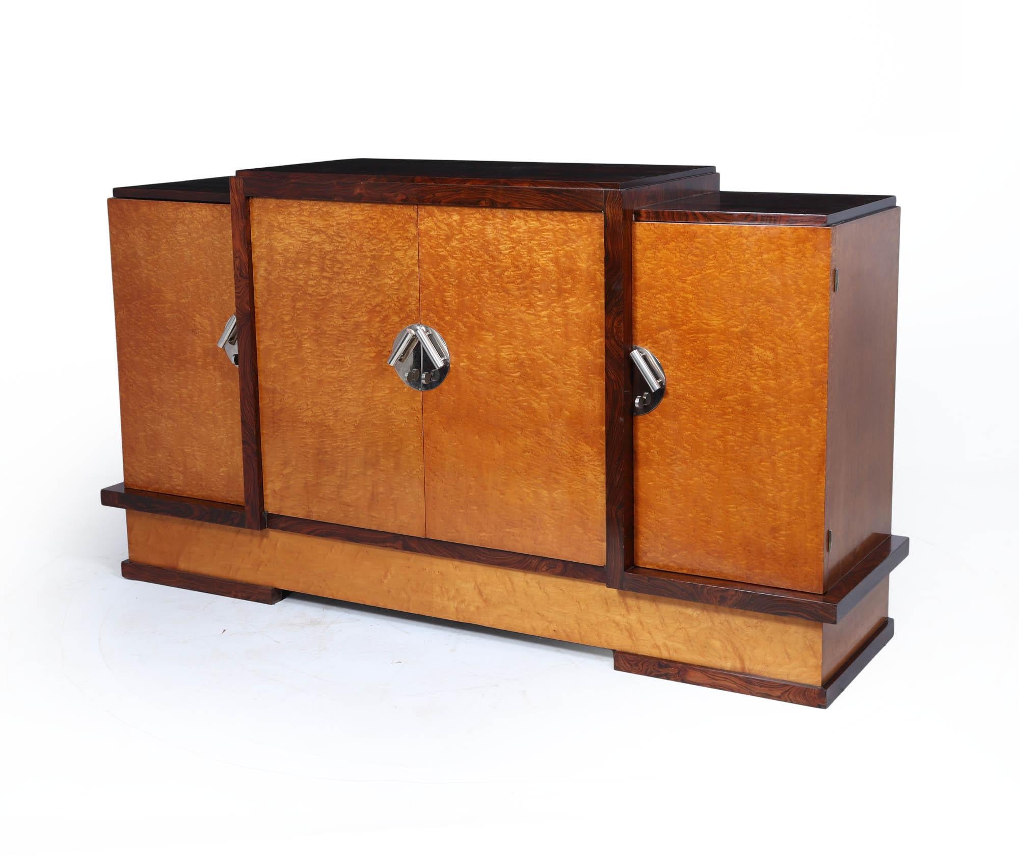 A rare and striking French Art Deco sideboard by acclaimed designer Michel Dufet, crafted in birdseye maple and rosewood, circa 1925. With its bold stepped silhouette and luxurious materials, this piece exemplifies the innovation and glamour of the