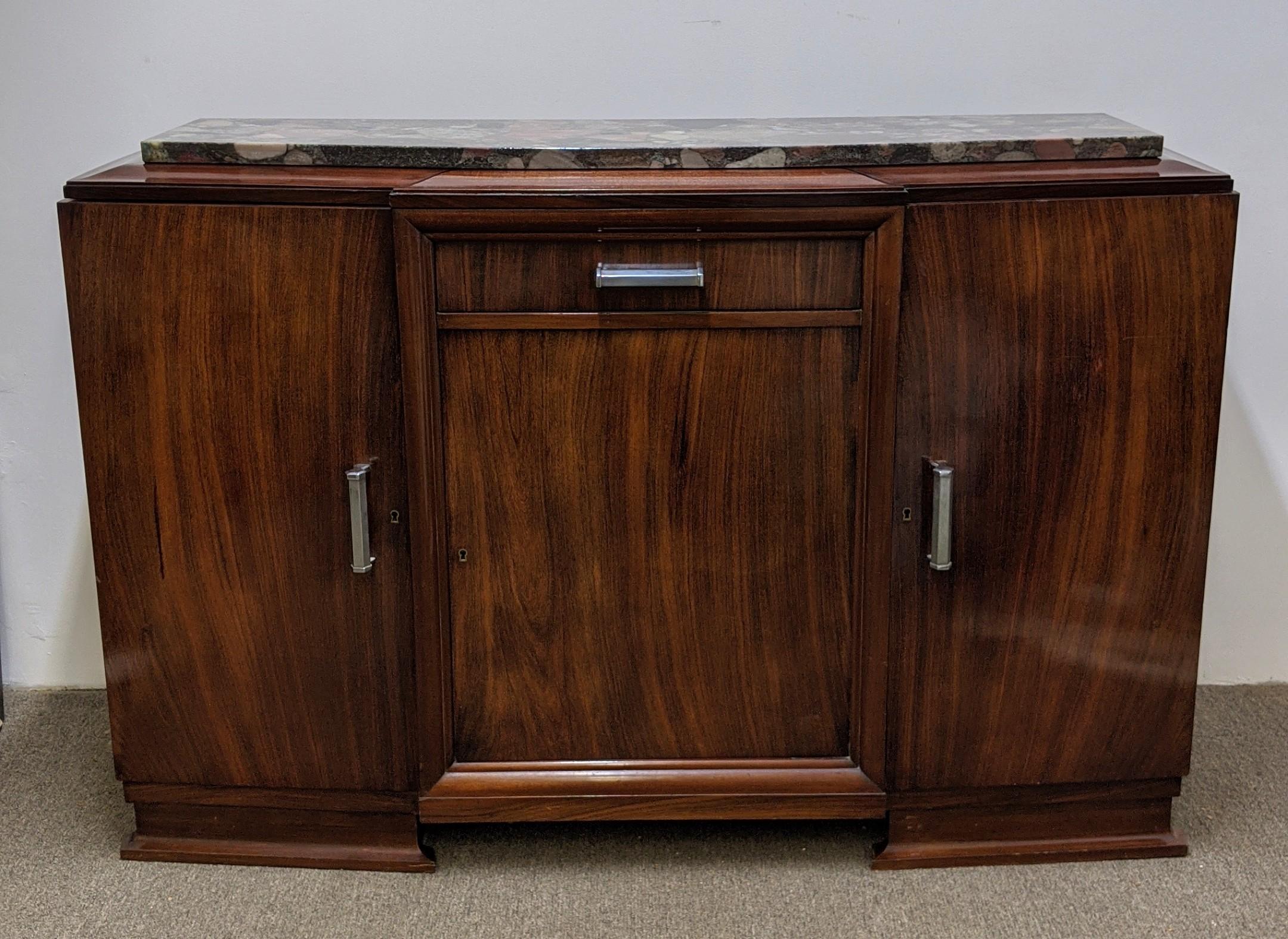 French Art Deco sideboard in walnut veneer marble top with Nickel hardware. Geometric modern clean line design accommodating three doors with a central draw. Need minor work. We are the rare source that specializes exclusively in French Art Deco for