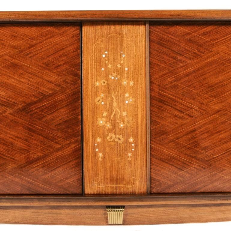 Gorgeous Art Deco sideboard with kingwood, satinwood, rosewood, and mother-of-pearl inlays which also features brass mounts. A stunning piece.





       