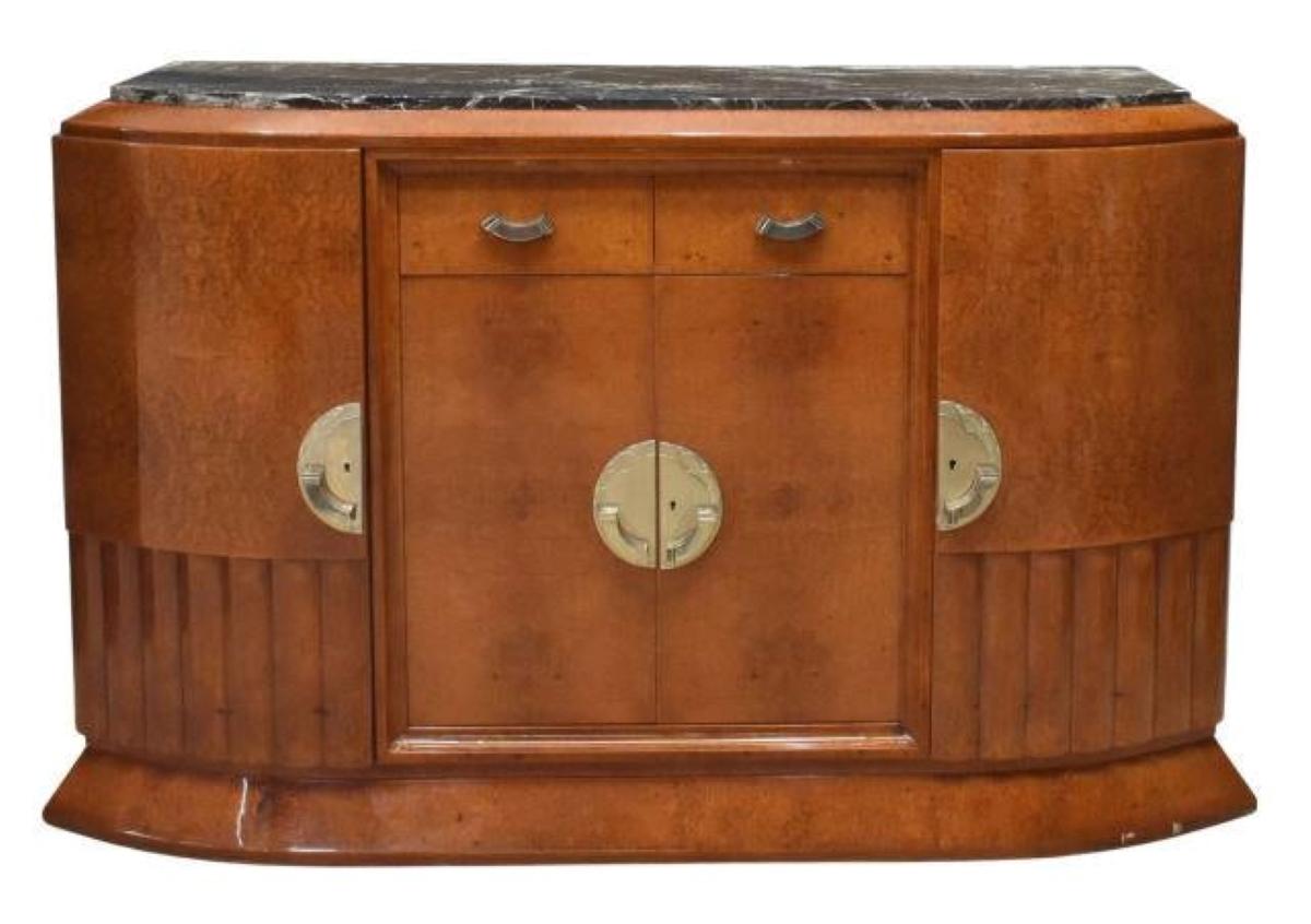 Exceptional French Art Deco elegant 1930's sideboard with inset marble top made out of amboyna burlwood in a high gloss finish, elaborately done with clear piano lacquer finish. Centered two drawers over a double door cabinet with interior