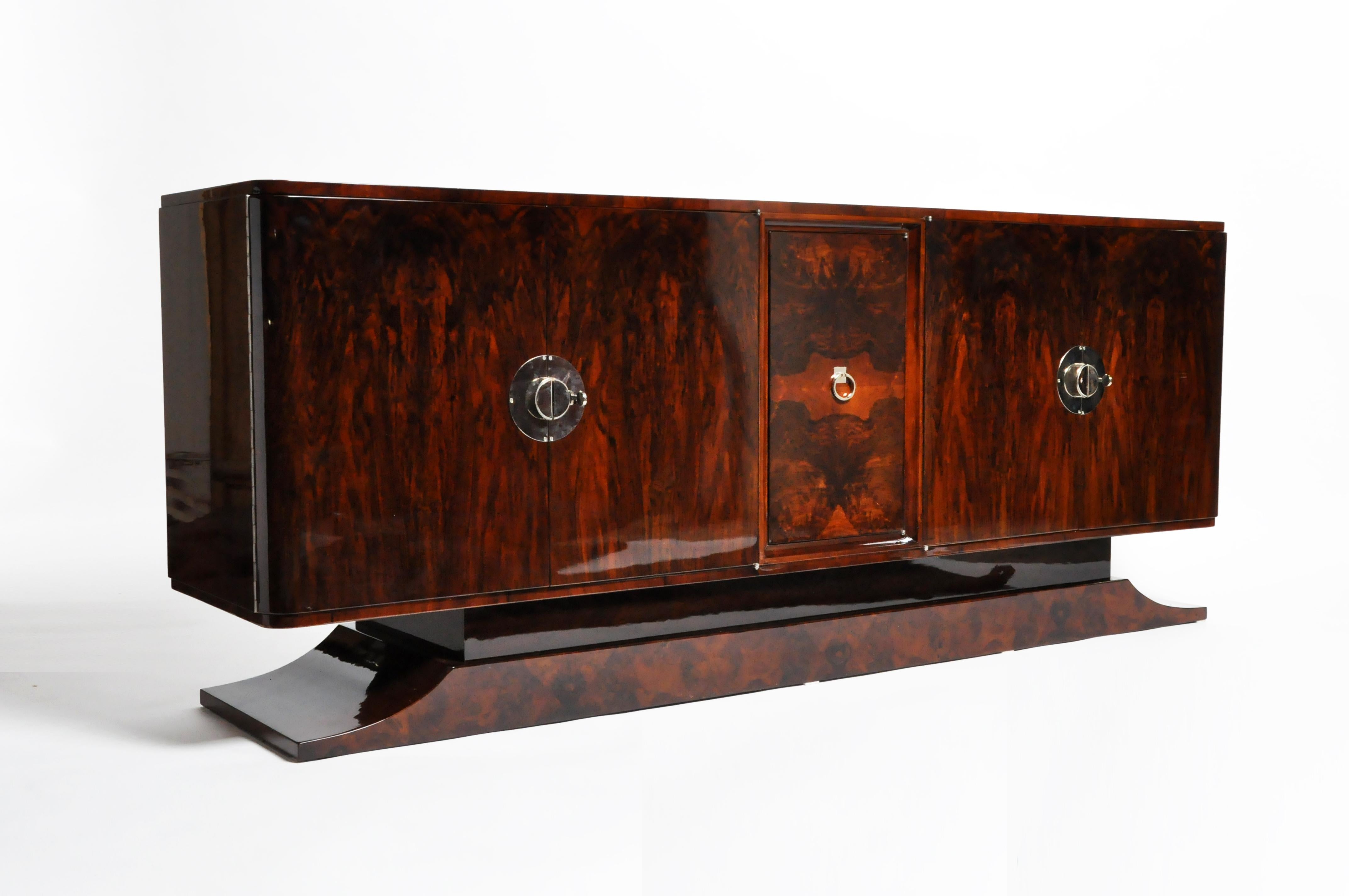 This is an exceptionally well-preserved and elegantly detailed Art Deco piece is from France and made from dark walnut veneer, circa 1940. The proportion of the piece austere and graceful. The piece features 7 drawers and 2 pairs of doors that come