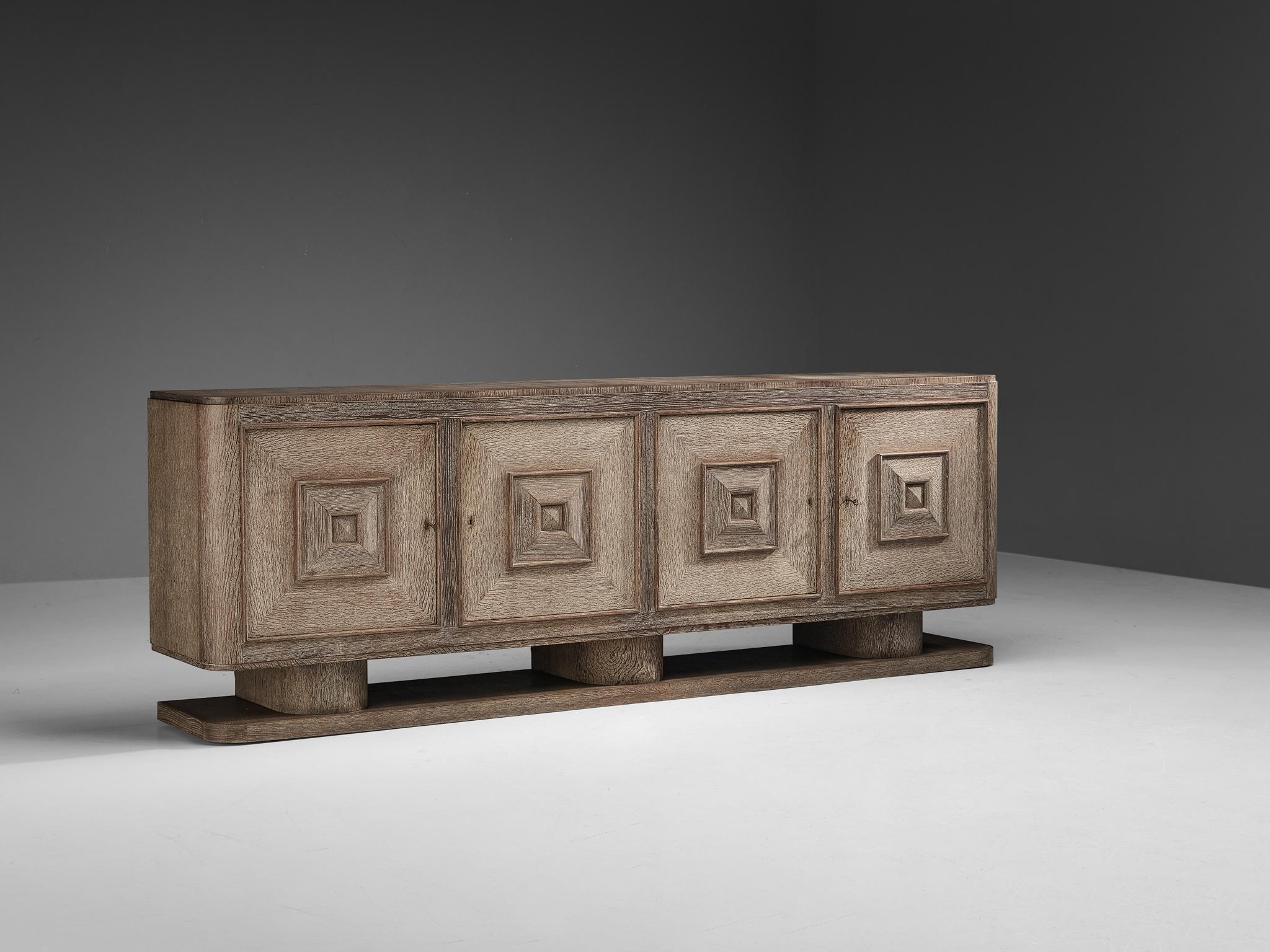 Sideboard, cerused oak, France, 1940s.

Stunning and monumental large sideboard in a light colored cerused oak. The partition of light and dark oak due to the technique used has a intriguing effect. This design is typical for the Art Deco period