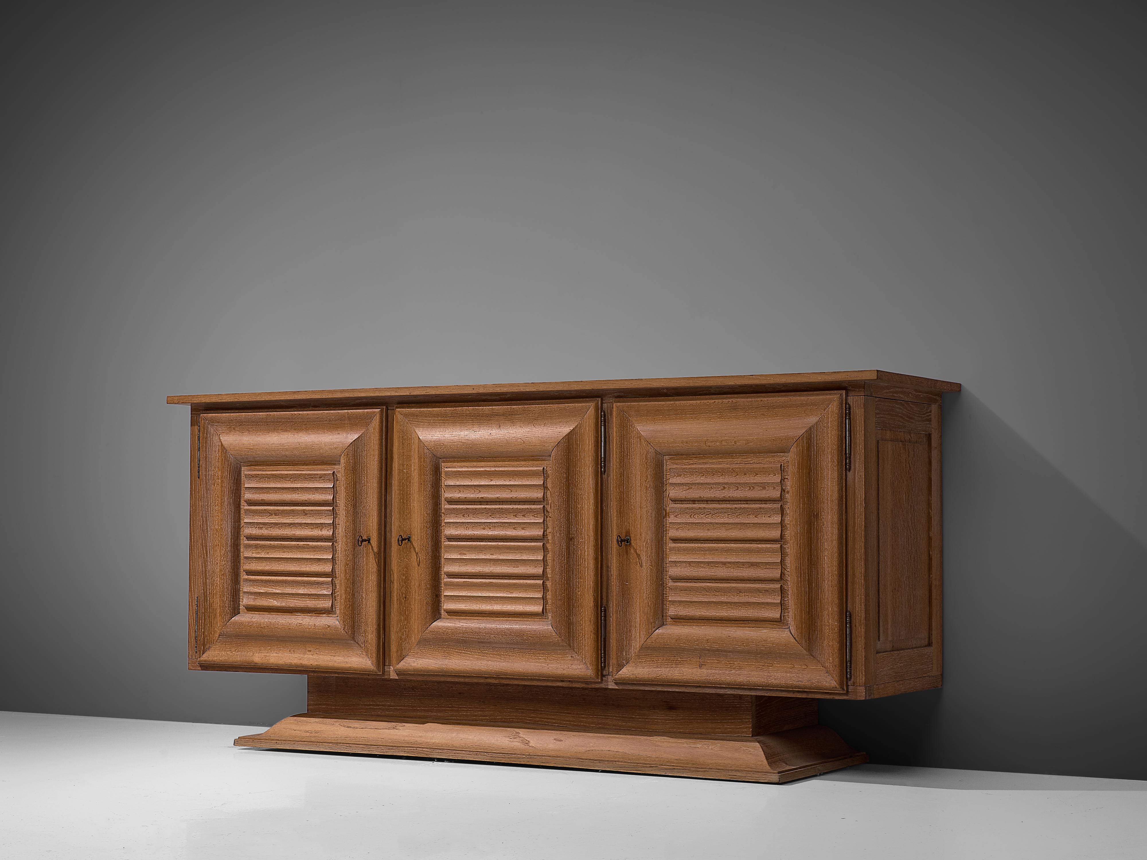 Credenza, oak, metal, France, 1940s. 

This charming sideboard undoubtedly breathes the Late Art Deco Period of the 1940s. Excellent craftsmanship is combined with a well-balanced eye for the composition of functional and decorative elements. The