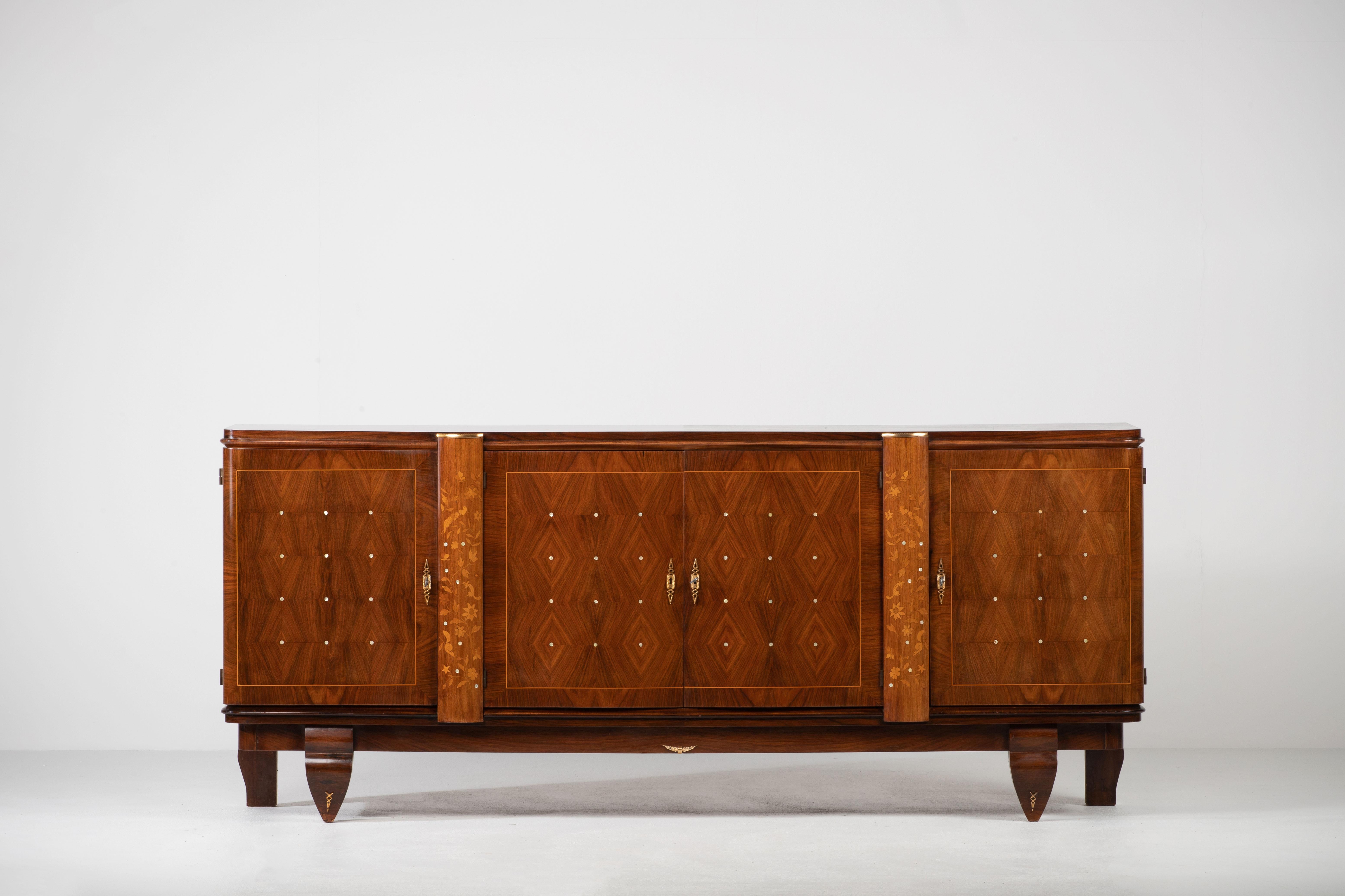 This French Art Deco sideboard, credenza was found in a little Castle in Normandy; France. 
The sideboard features stunning Lemon tree wood grain with a thin decorative mother of pearl inlay design with butterflies and birds. 
The inside is also a