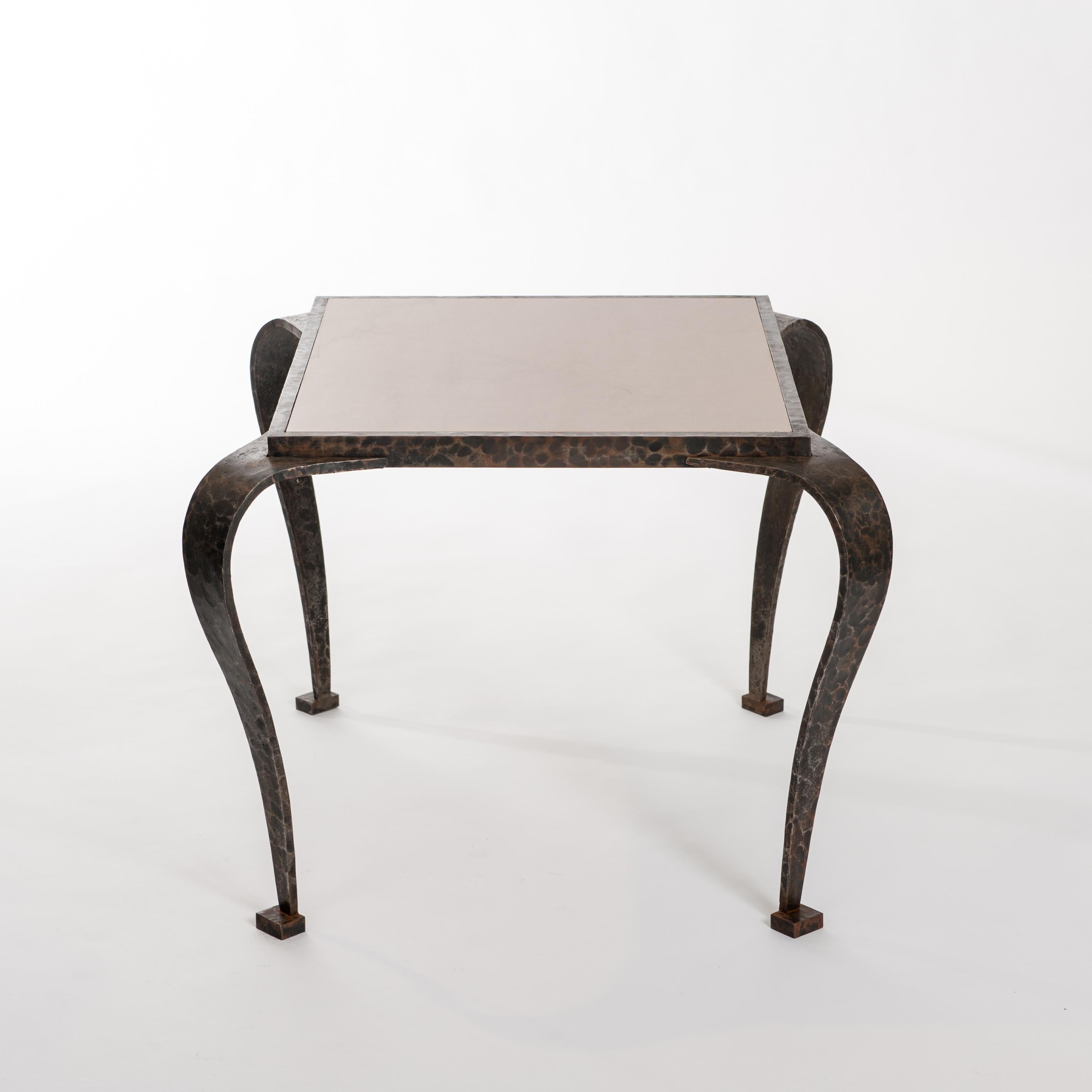 Impressive iron Art Deco side table with hammered surface and elegant curved legs.
The side table displays an extraordinary impressive look due to its hand forged, hammered surface and the marble top.
The rusty brown-grey color of the waxed iron