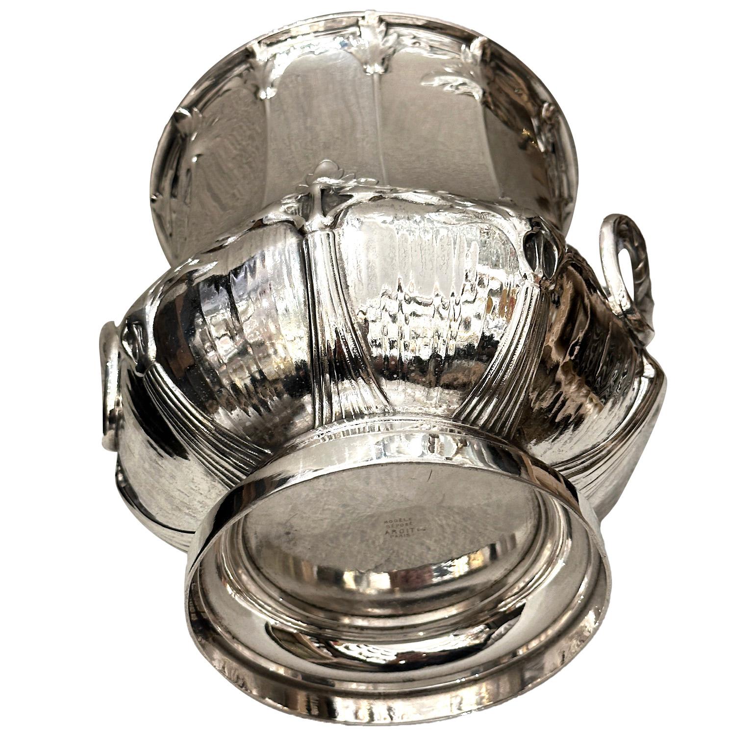 Pair of silver-plated champagne buckets dating from the late 19th century, signed by Maison Argit, silversmiths specializing in tableware. Each bucket stands on an elegant pedestal base and features finely crafted handles adorned with chervil