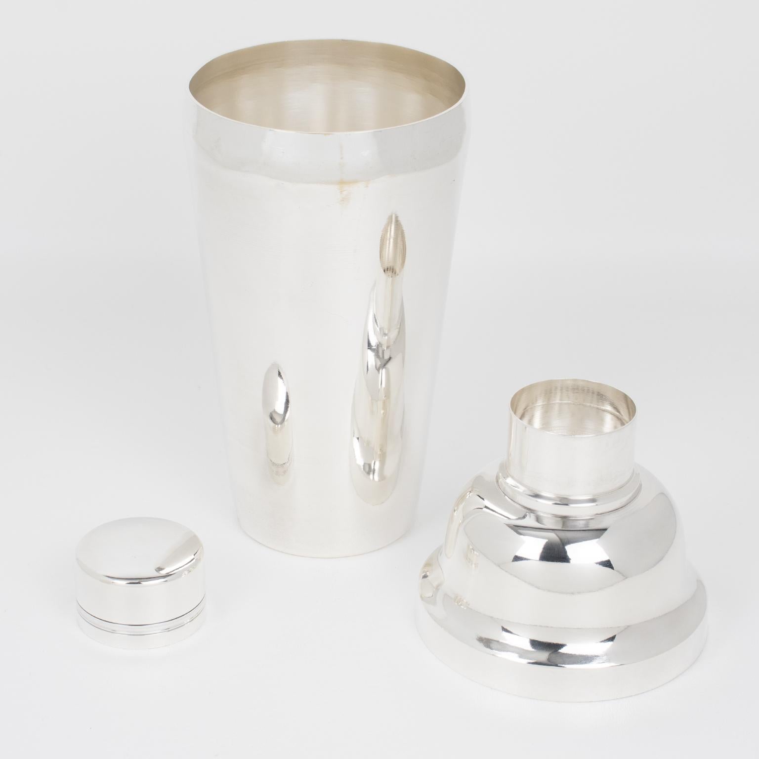 French silversmith Ets Boyer et Fils, Paris, crafted this elegant Art Deco silver plate cylindrical cocktail or Martini Shaker in the 1940s. The three-sectioned cocktail shaker has a removable cap and strainer. This accessory for barware has a