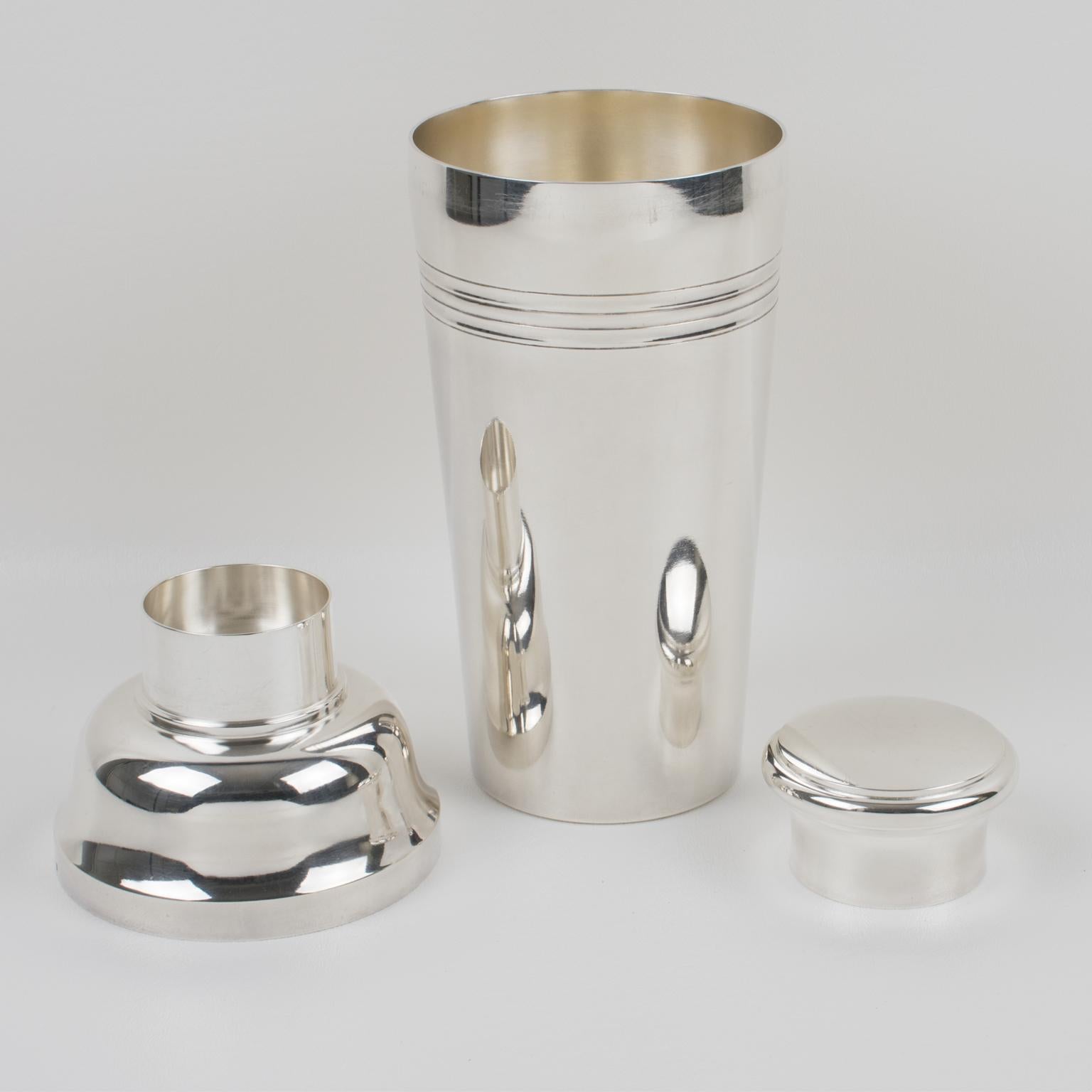 Elegant French Art Deco silver plate cylindrical cocktail or Martini shaker by silversmith Ste S. & Cie, Paris. Three sectioned designed cocktail shaker with removable cap and strainer. Lovely Art Deco flair with geometric design. Marked underside