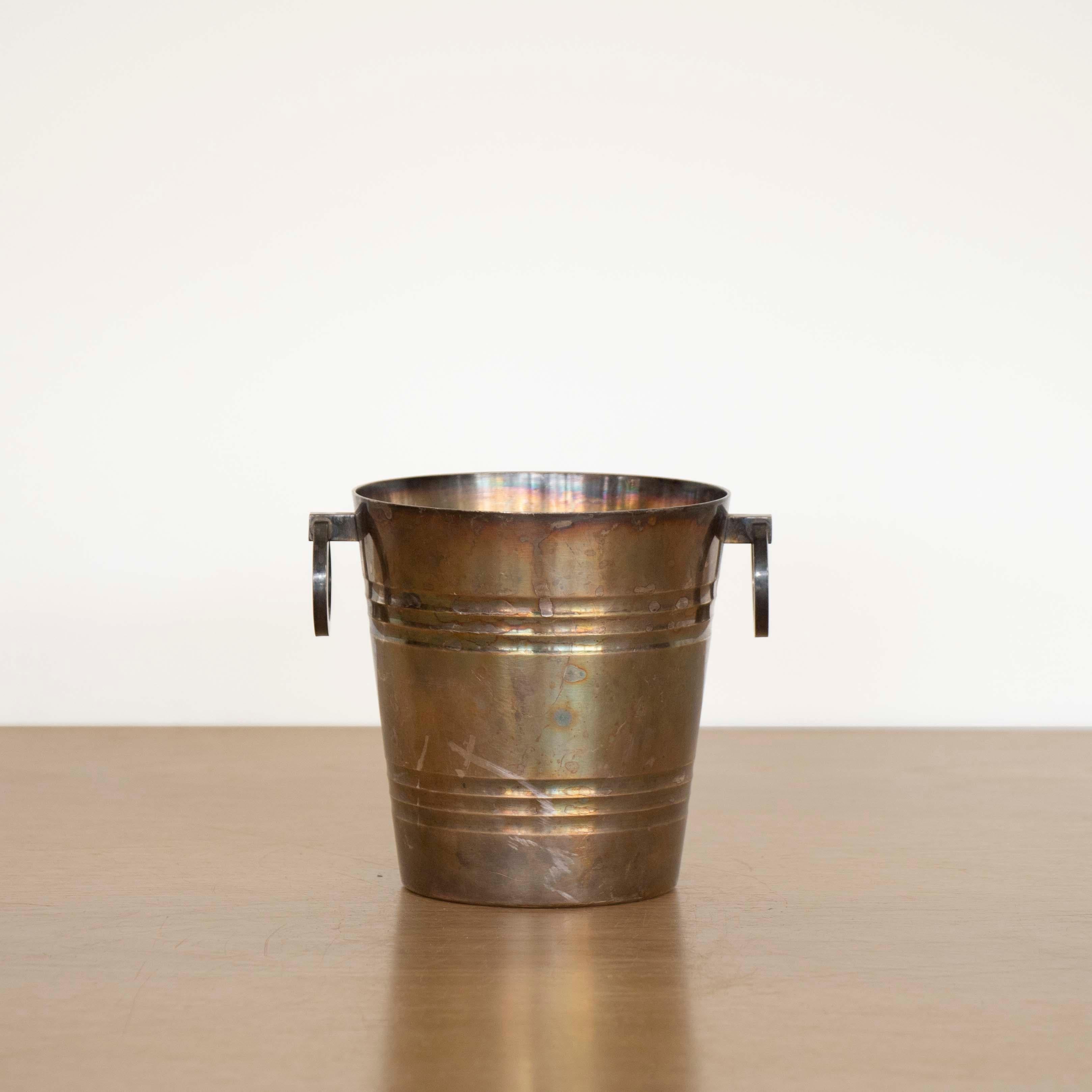 Great Art Deco silver plate ice bucket by St. Medard from France, 1930's. Tapered bucket with grooved rings around edge and two hinged ring handles. Lovely age and patina. Stamped on underside. 