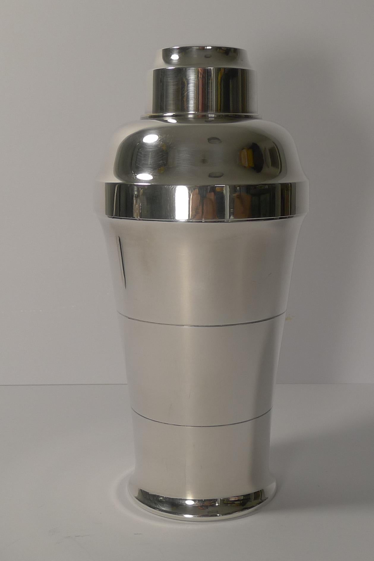 A fabulously shaped cocktail shaker made in France by the well renowned silversmith, St Médard, Paris, fully marked on the underside.

Art Deco in style and era, dating to the 1930s, the silver plate remains intact and in excellent condition with