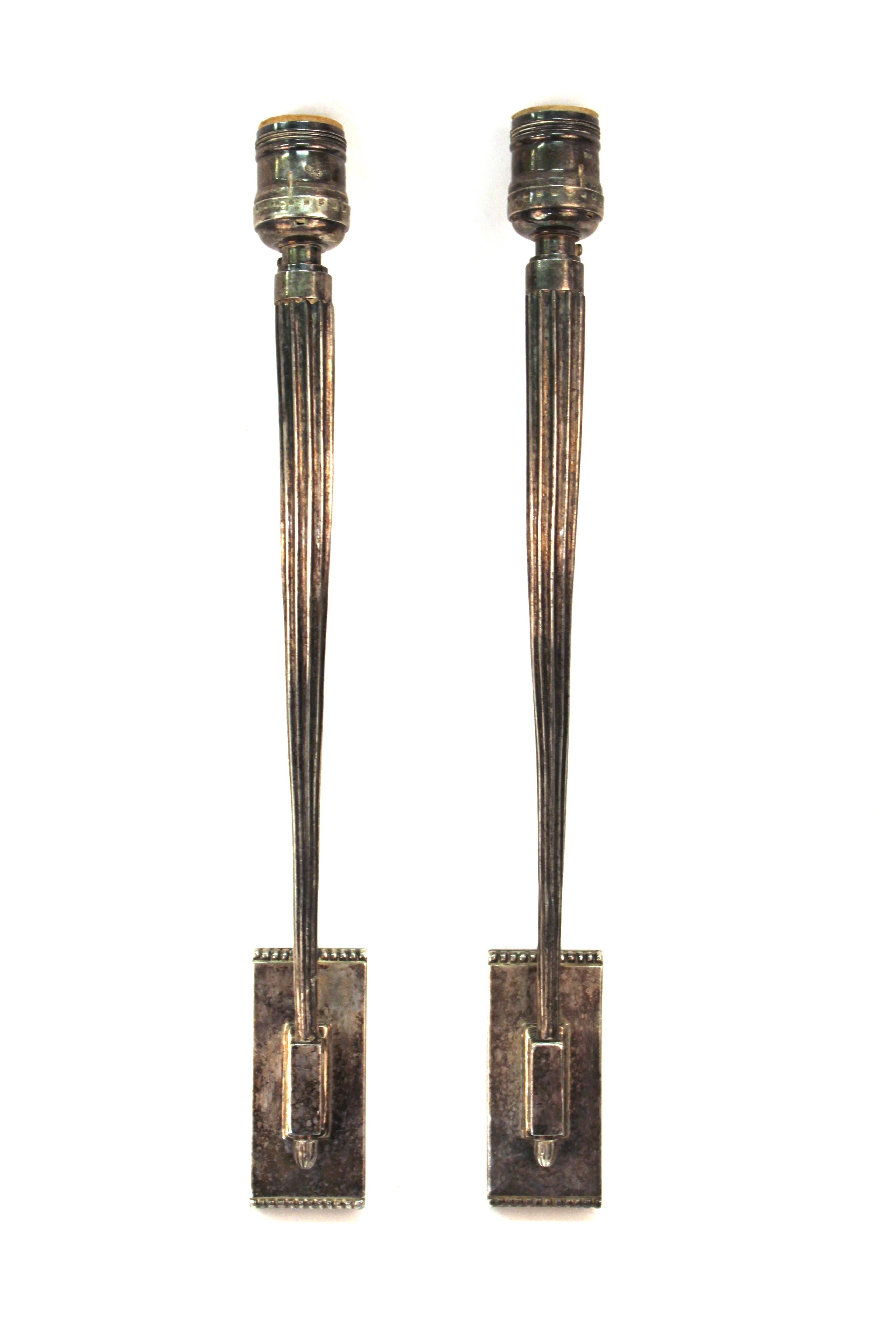 French Art Deco period pair of wall sconces in silvered bronze, attributed to Émile-Jacques Ruhlmann. The pair was likely made during the 1920s-1930s and is in great vintage condition with age-appropriate wear and patina.
