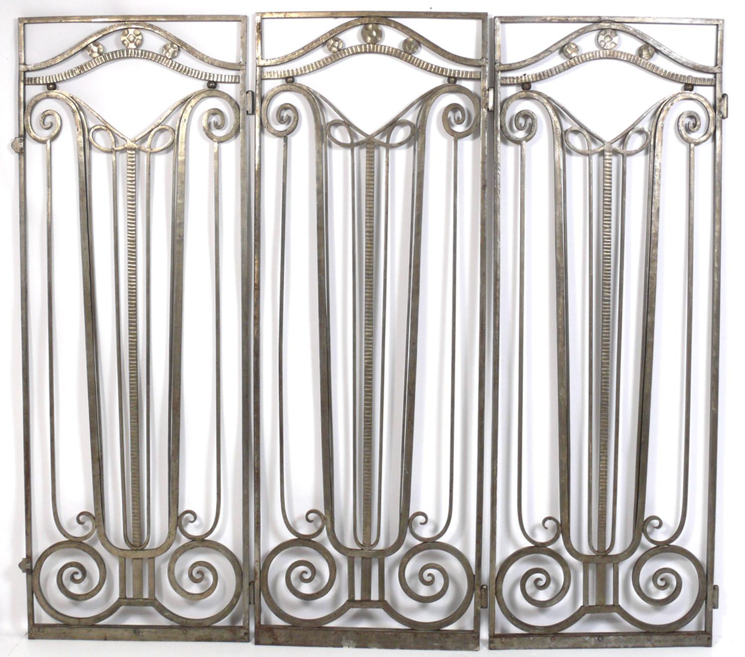 French Art Deco Silvered Iron Gates, in the manner of Edgar Brandt, unsigned, France, circa 1930s. They are a wonderful example of architectural salvage, constructed of hand wrought iron. They retain their original patina with some isolated areas of
