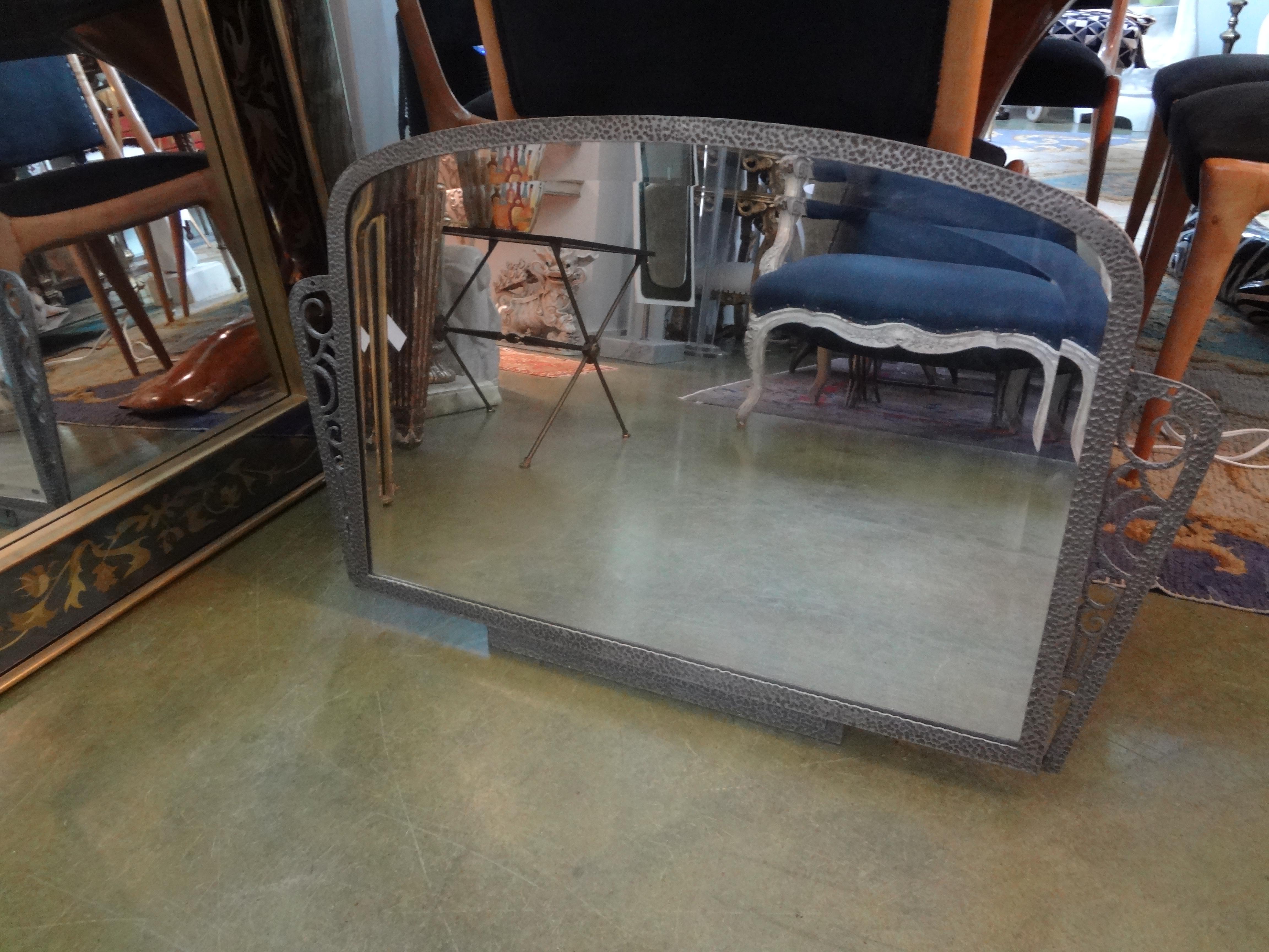 French Art Deco silvered wrought iron beveled mirror.
Handsome French Art Deco Edgar Brandt inspired silvered horizontal wrought iron beveled mirror. This shapely French Art Deco Mirror has a beautiful hammered finish.