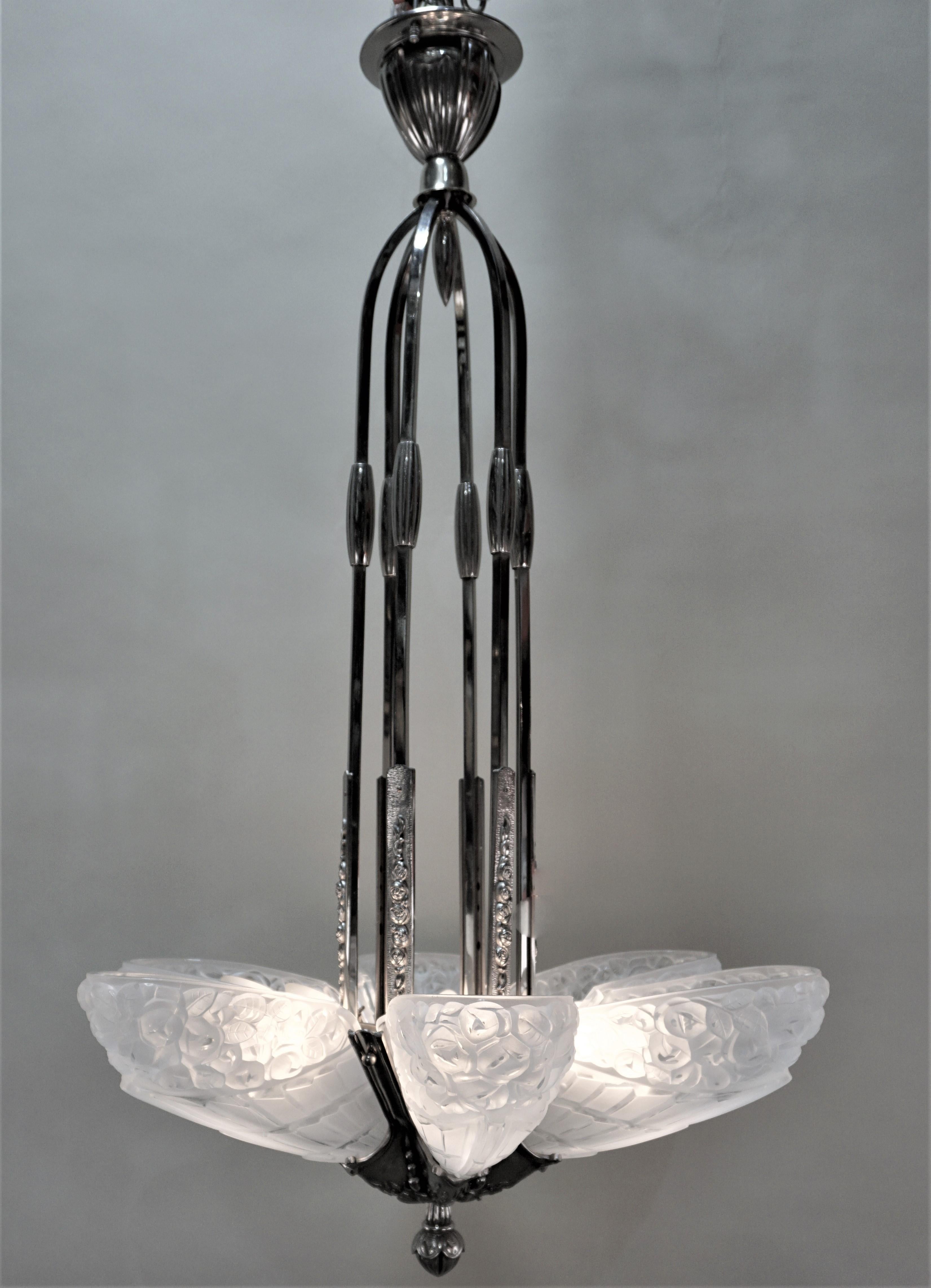 Six clear frost glass with high light polish, nickel on bronze frame chandelier.
Total of 12 lights, 60 watt max each.