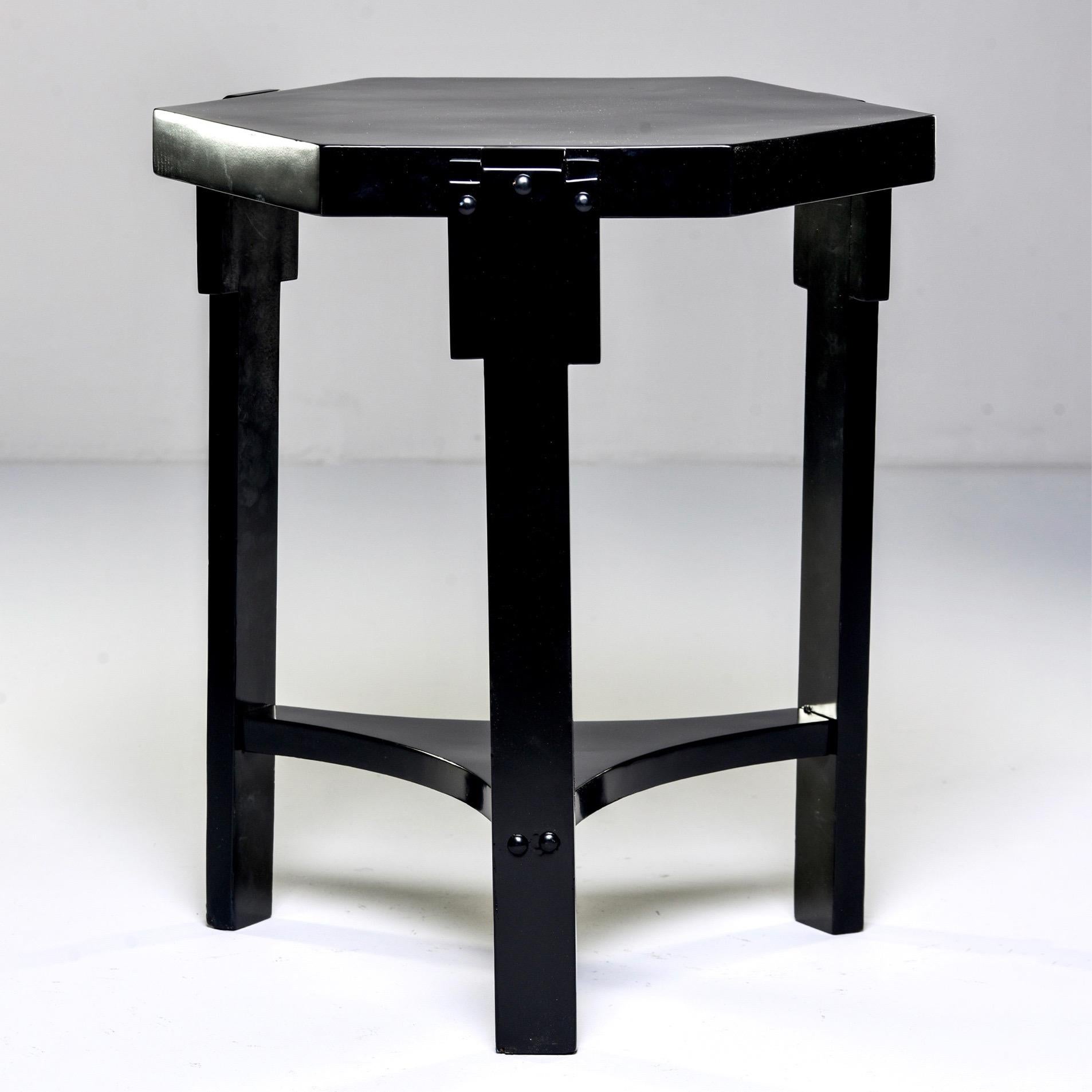 French Art Deco side table features three legs, a lower shelf and six-sided top with stylized stepped supports and a new black finish, circa 1930s. Unknown maker.