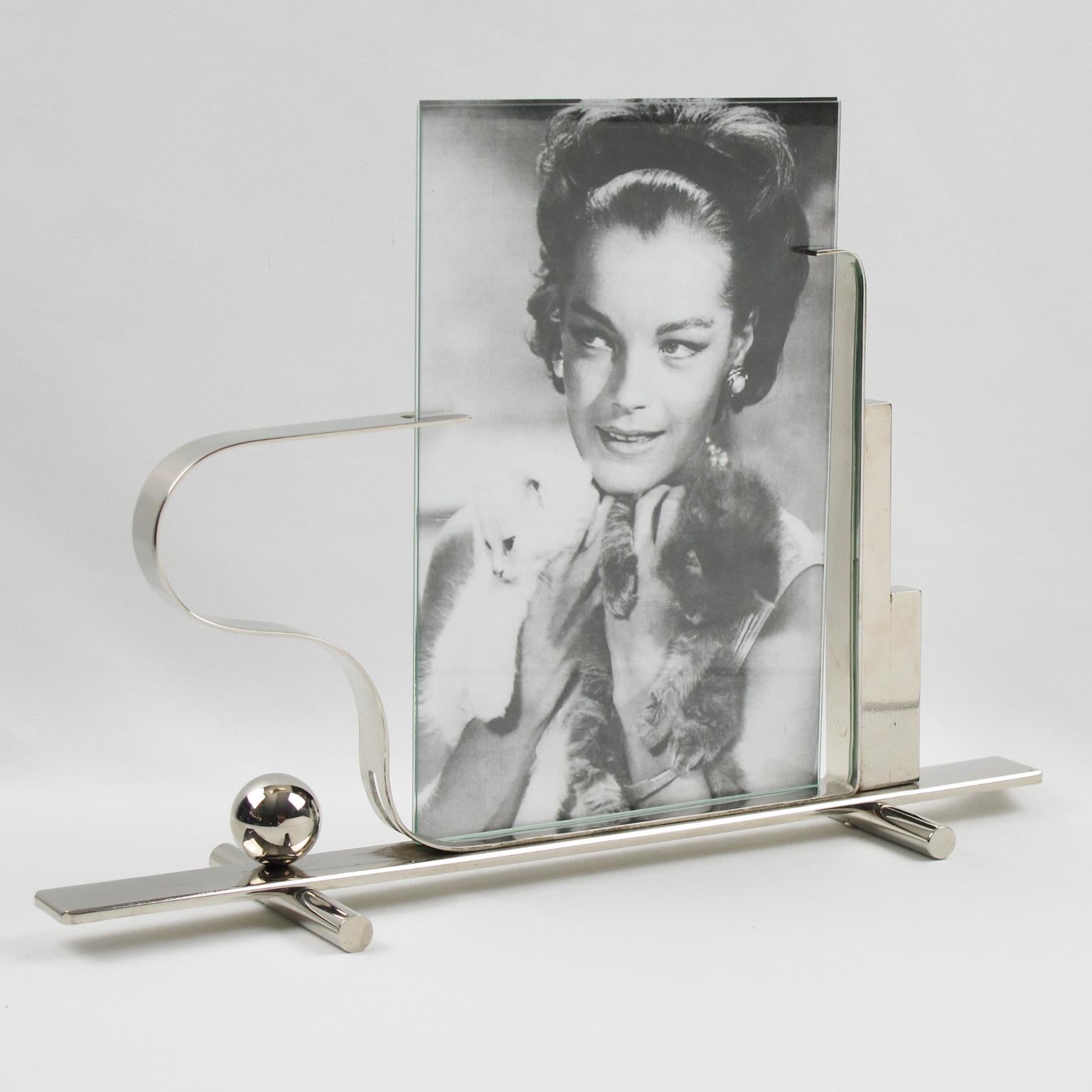 Sculptural French Art Deco chrome picture photo frame. Heavy chromed metal with skyscraper shape and asymmetric holders. Chromed metal plinth base with large rod feet compliment with chrome bead accent and geometric holders. The frame is complete