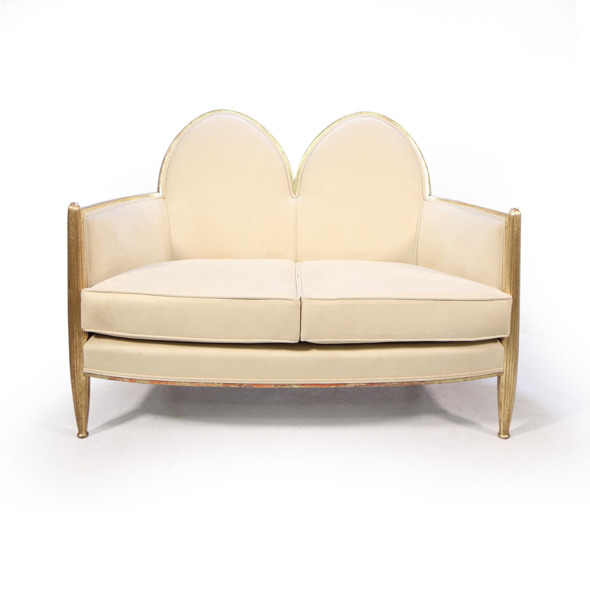 A fine quality parcel gilt double shield back sofa, with two toned gilding the turned and fluted legs are gold leaf and the frame is white gold, this has 70% of original gilding and we have had it carefully matched in keeping the patina to the gold.