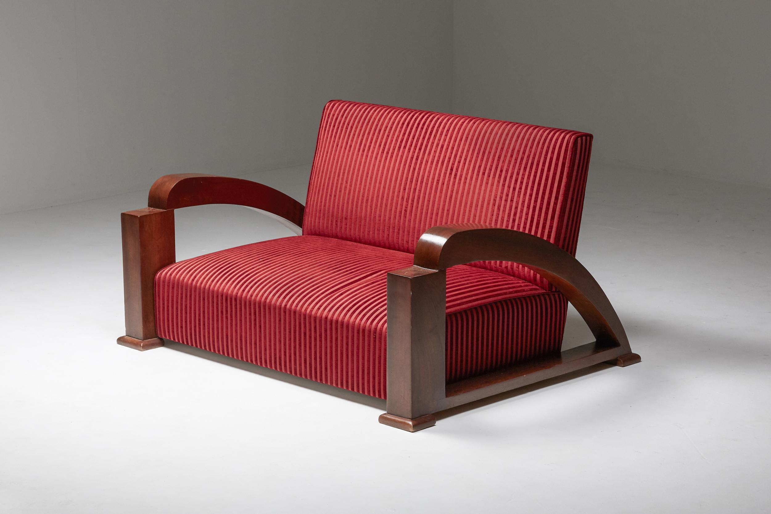 Art Deco; sofa; Settee; two-seater; living room set; Striped fabric; Red velvet; France; 1930; Jean Royère; 

This impressive Art Deco sofa dates from the beginning of the 20th century. The curvy armrests give this bulky piece an elegant and