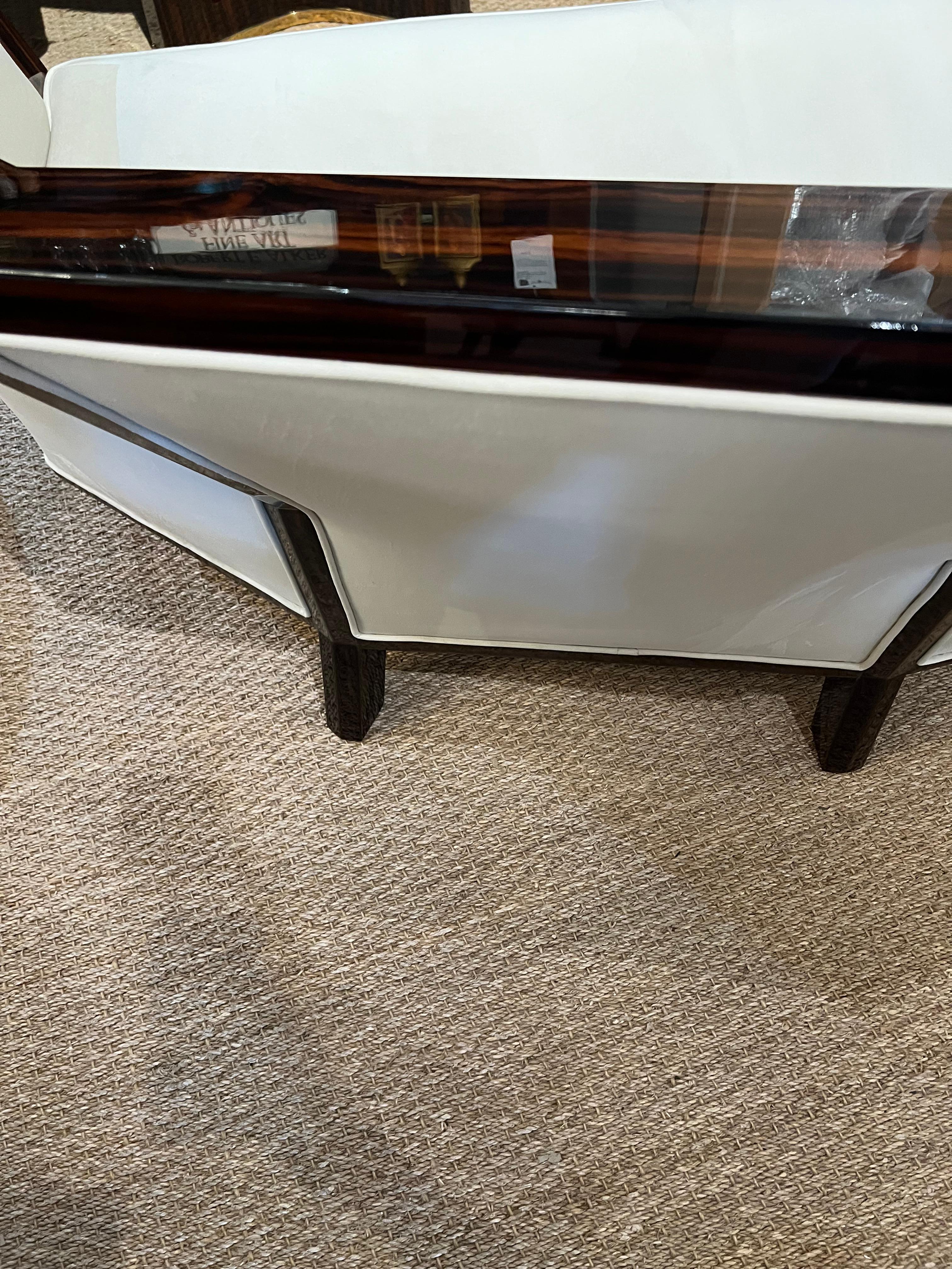  French Art Deco Sofa in the style of Pierre Chareau

 The sofa is made out of walnut wood, re-upholstered with a light color velvety fabric. Resting on elongated rectangular legs. 
The condition is very good. Restored. 

       Farnce, c. 1930
    
