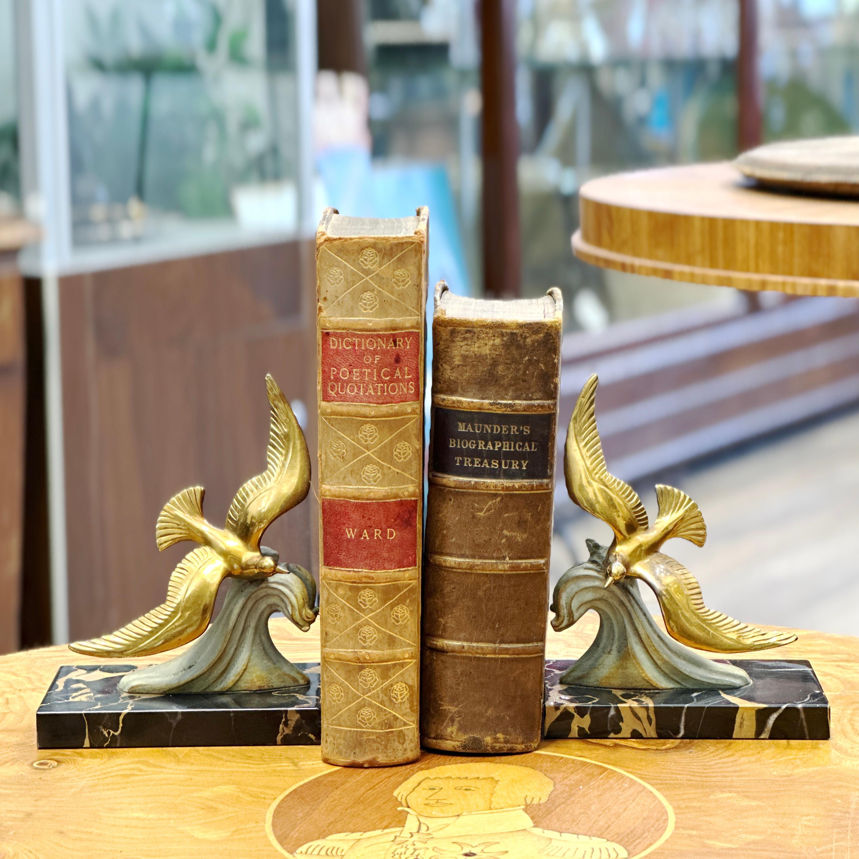 Here is a lovely pair of French Art Deco Spelter Brass and Marble Bookends. These bookends feature two brass sea birds in flight attached to a beautiful spelter wave formation. Each attached to a marble base. A wonderful display for your book